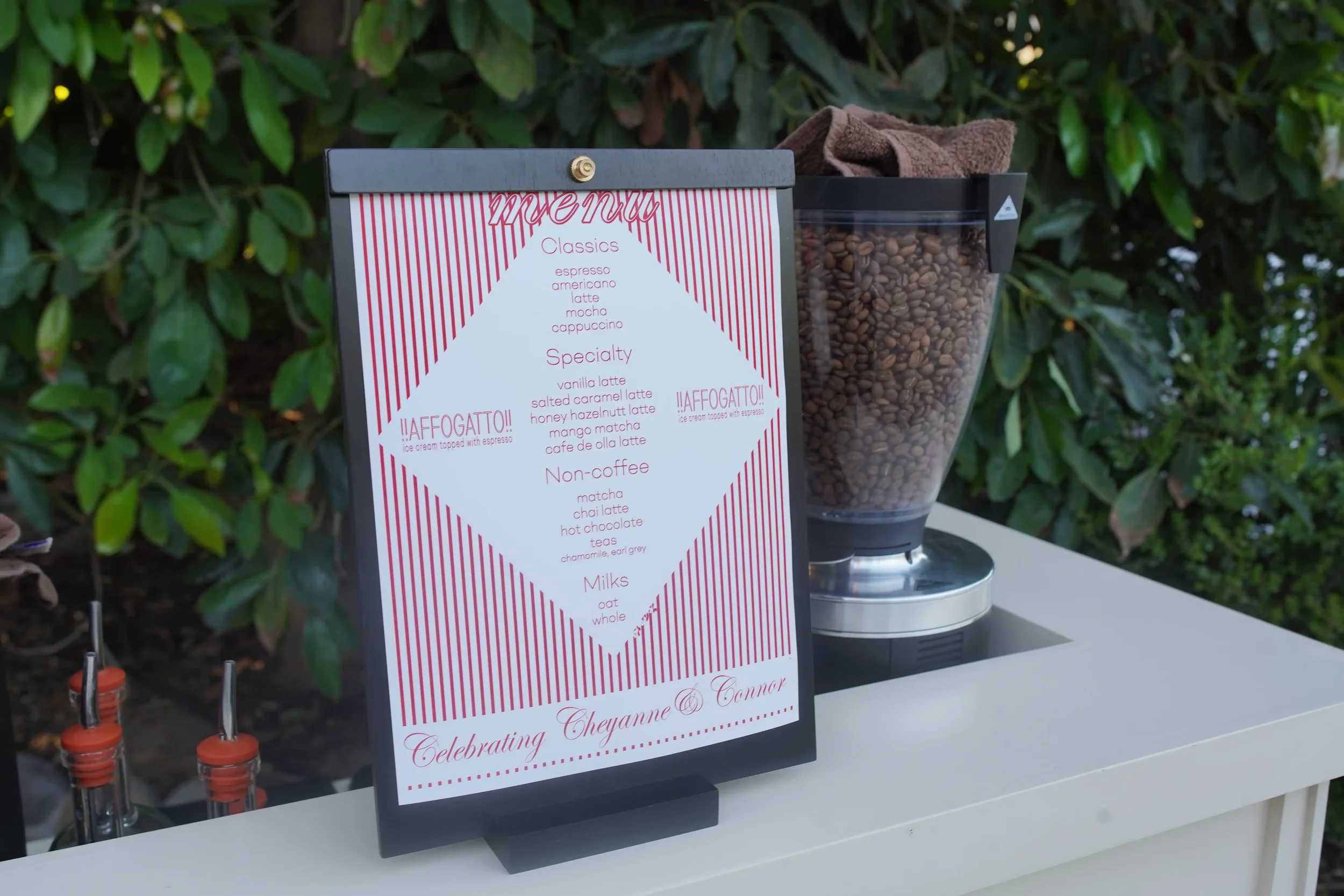 The event menu card beside a grinder full of fresh beans