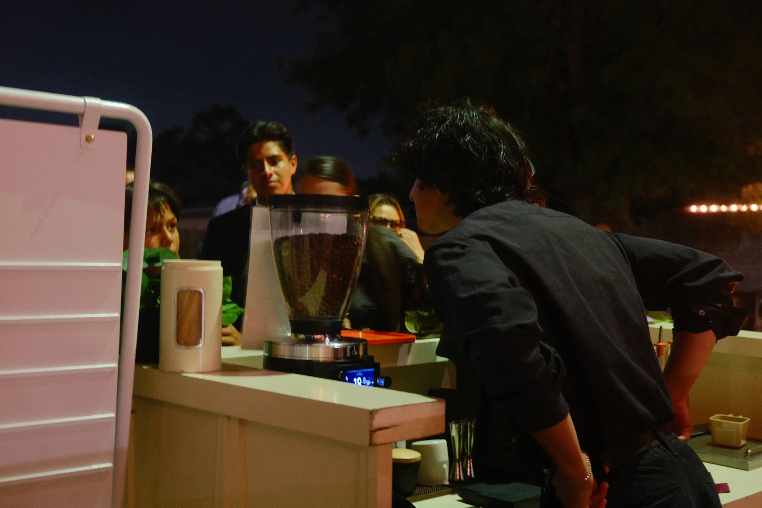 Eyevel barista crafting drinks behind the espresso bar