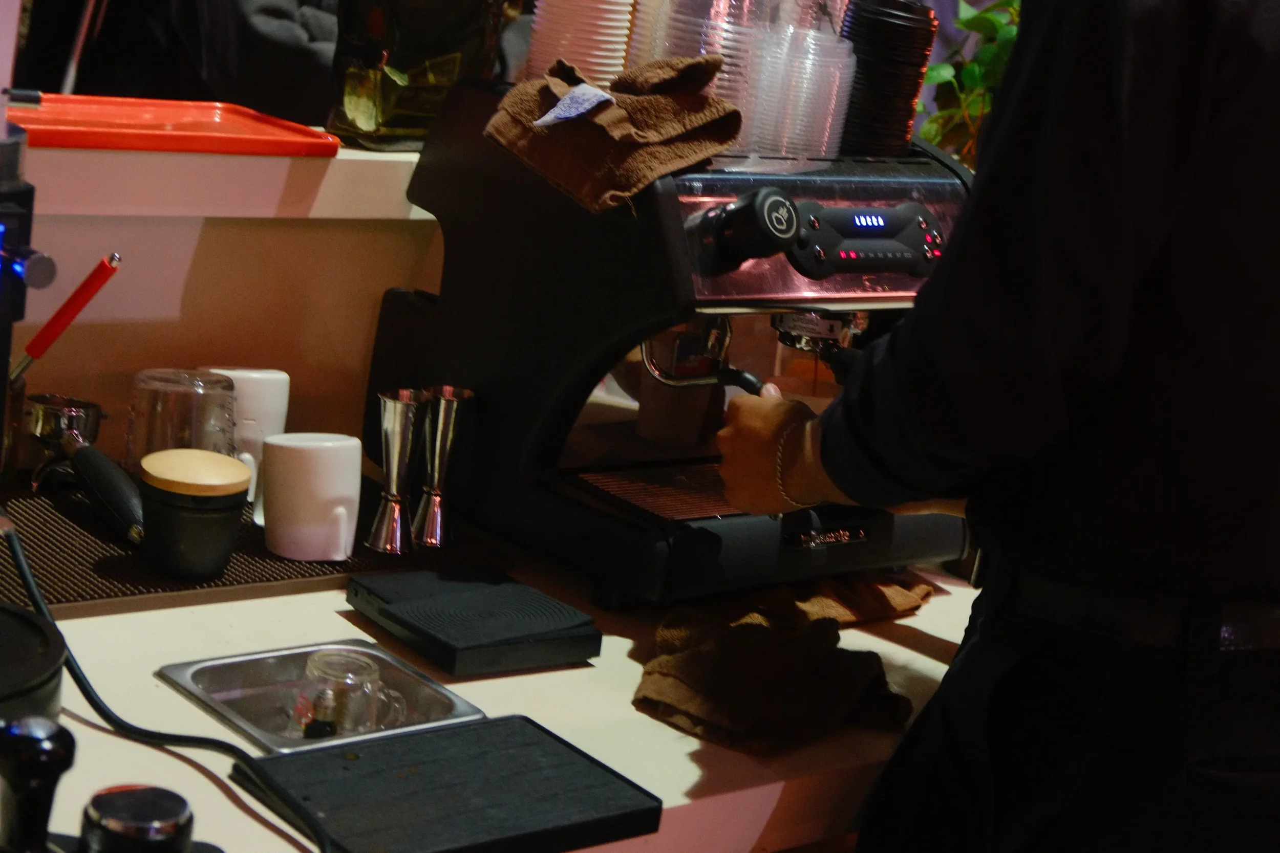 Eyevel barista crafting drinks behind the espresso bar