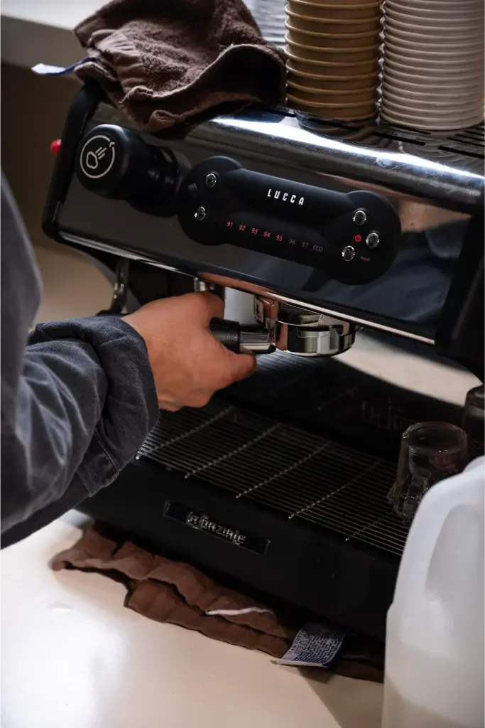Eyevel barista crafting drinks behind the espresso bar