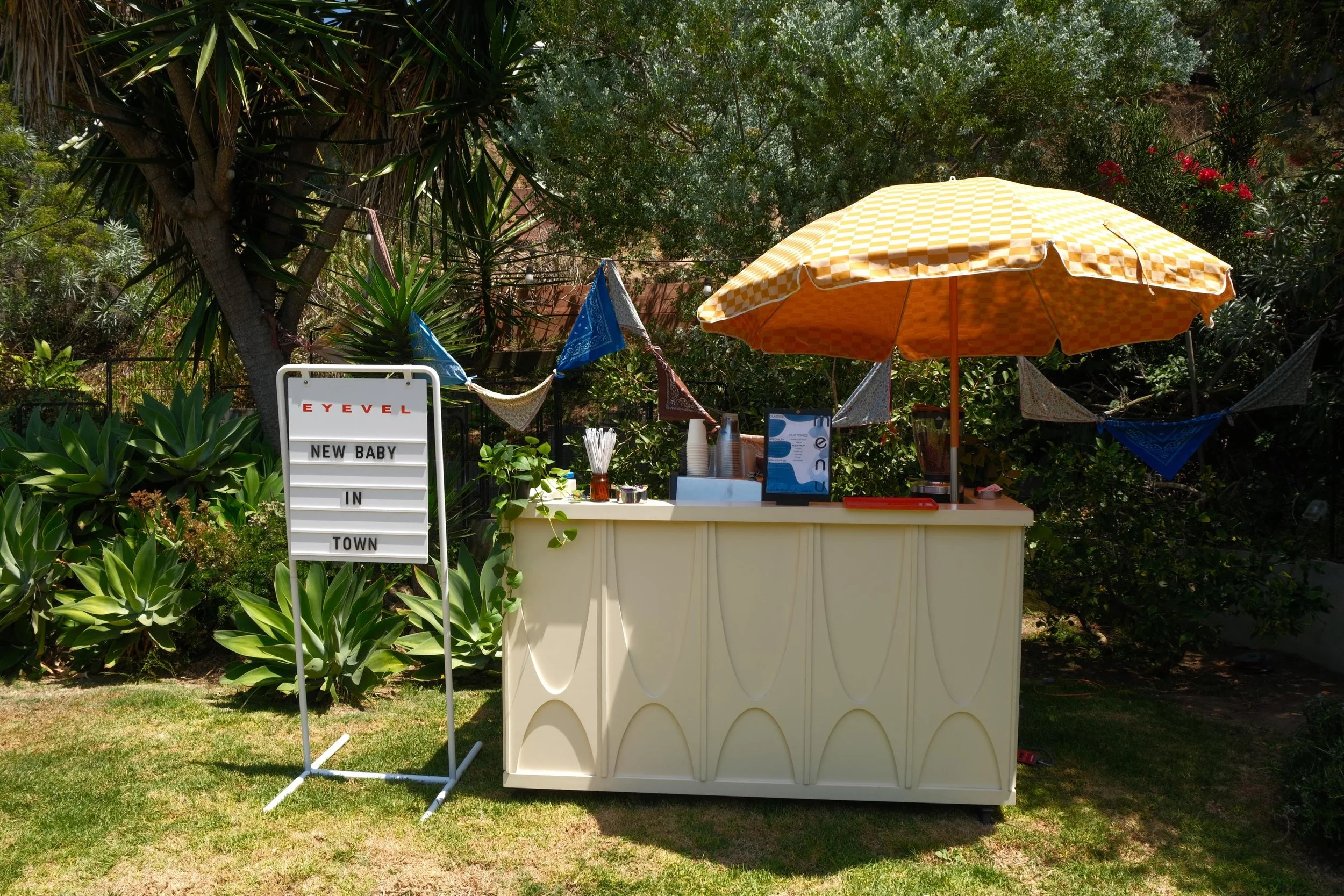Backyard party coffee bar with bunting and festival umbrella
