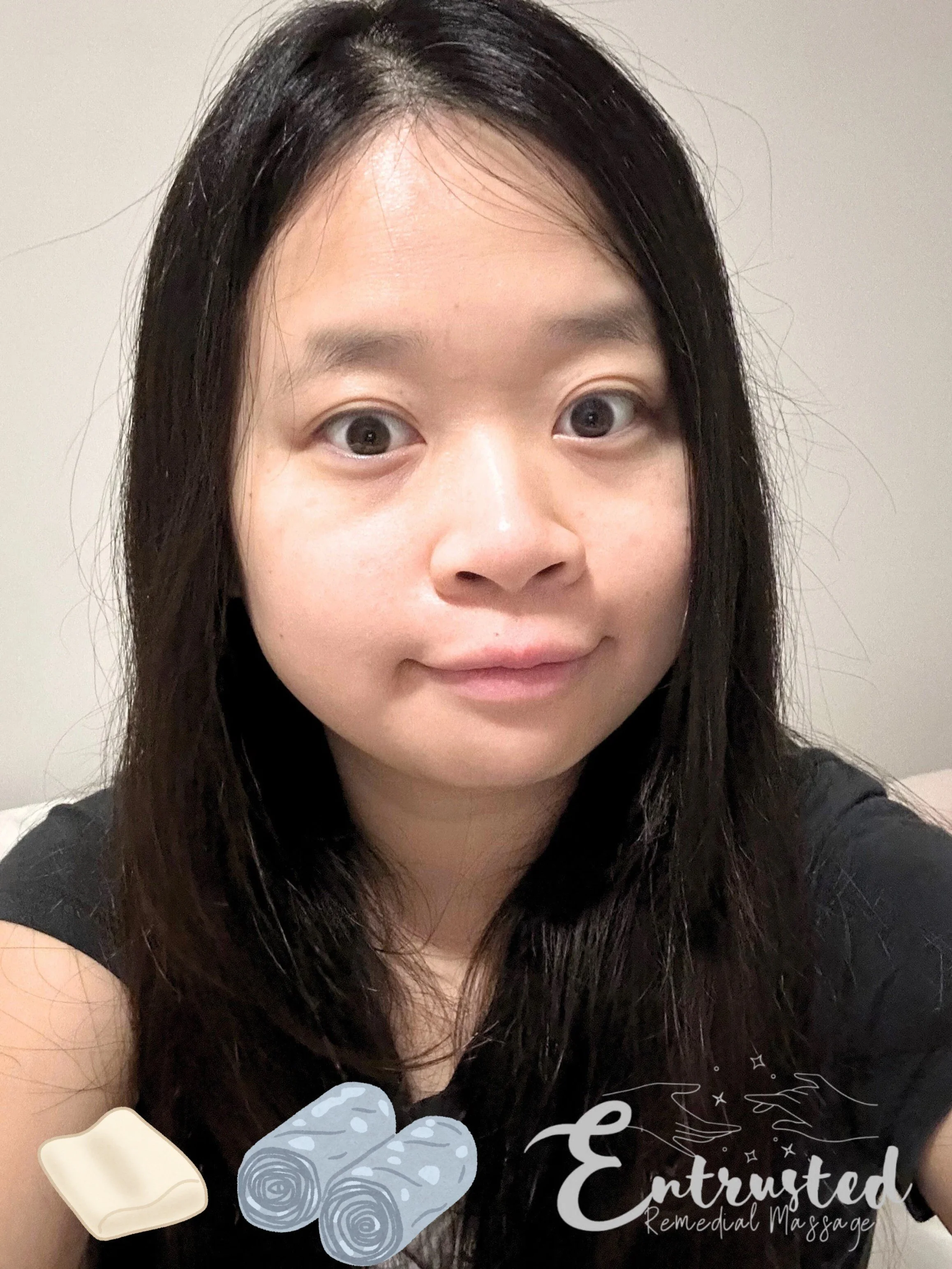 A young Asian female dressed in balck with long air and with images of towels and massage equipment 