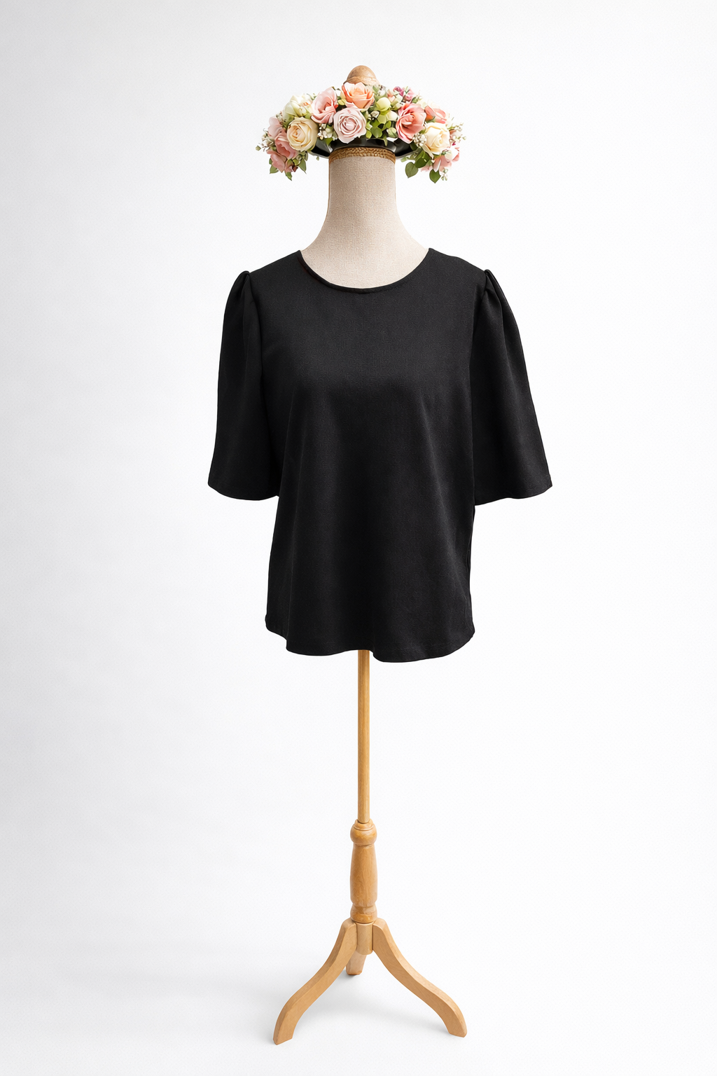 Black blouse with floral crown display.png