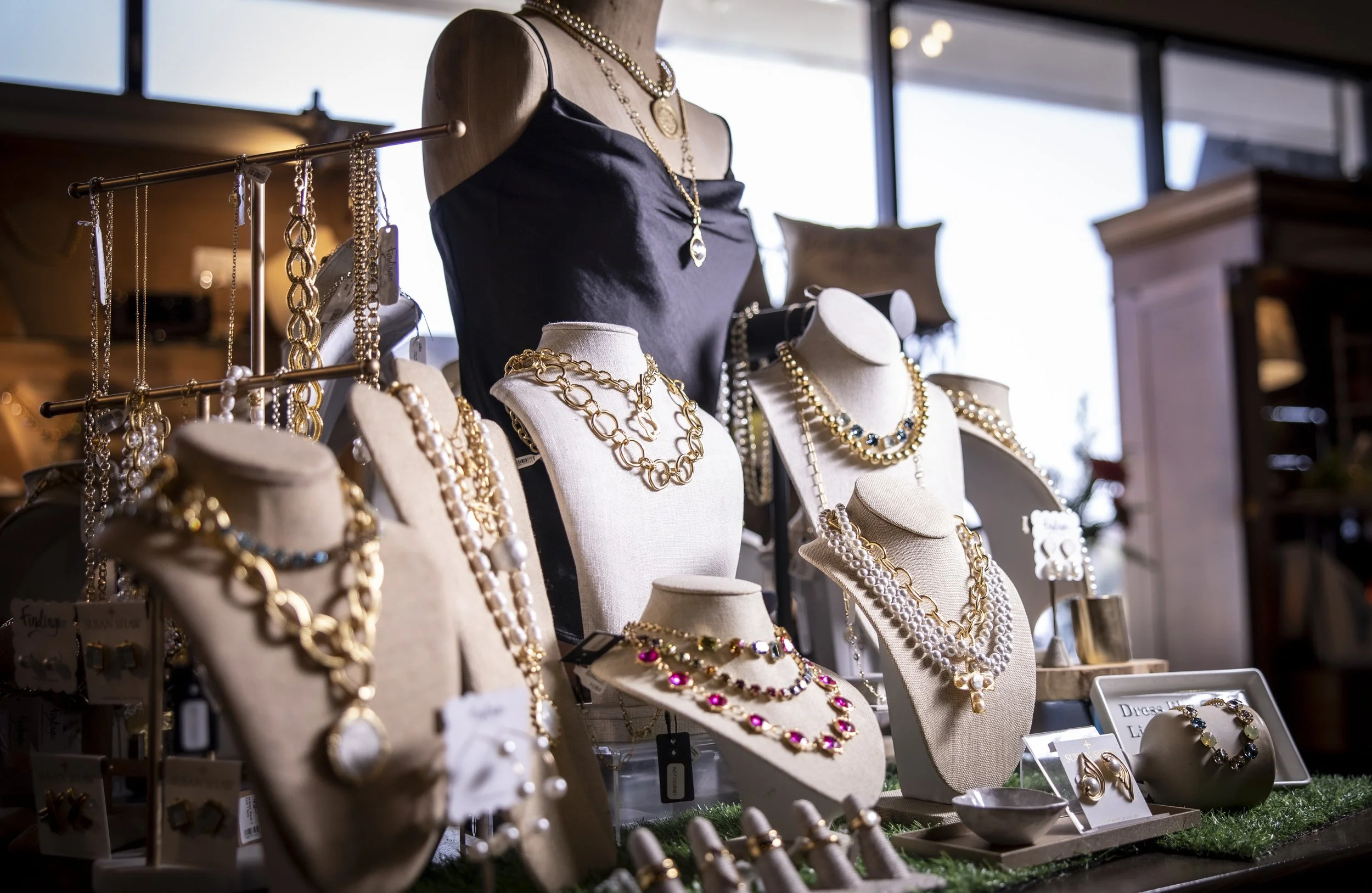 Jewelry displayed on mannequins as well as a black shirt