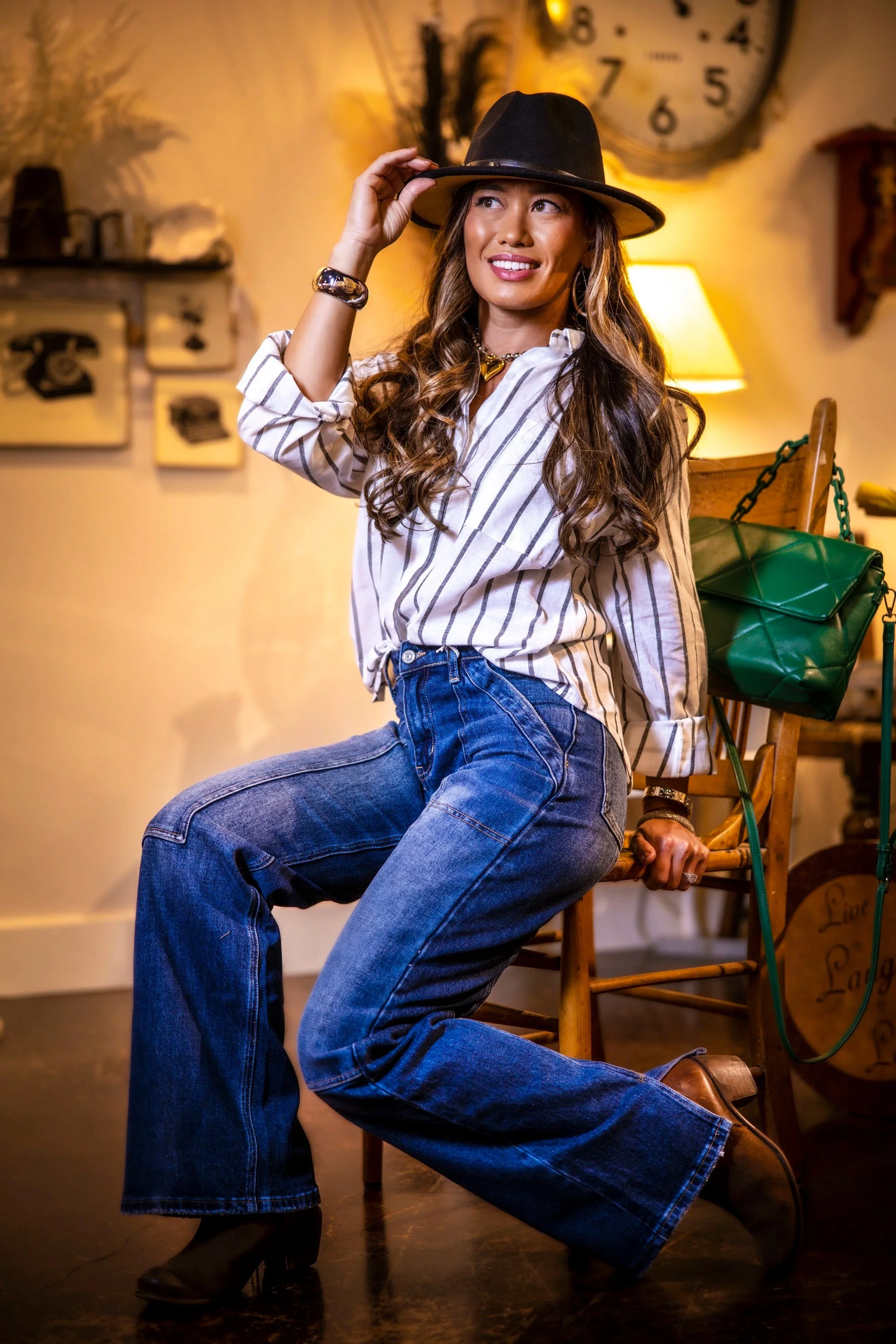 Girl with Striped Shirt and Fedora and Green Bag Sitting on a Chair