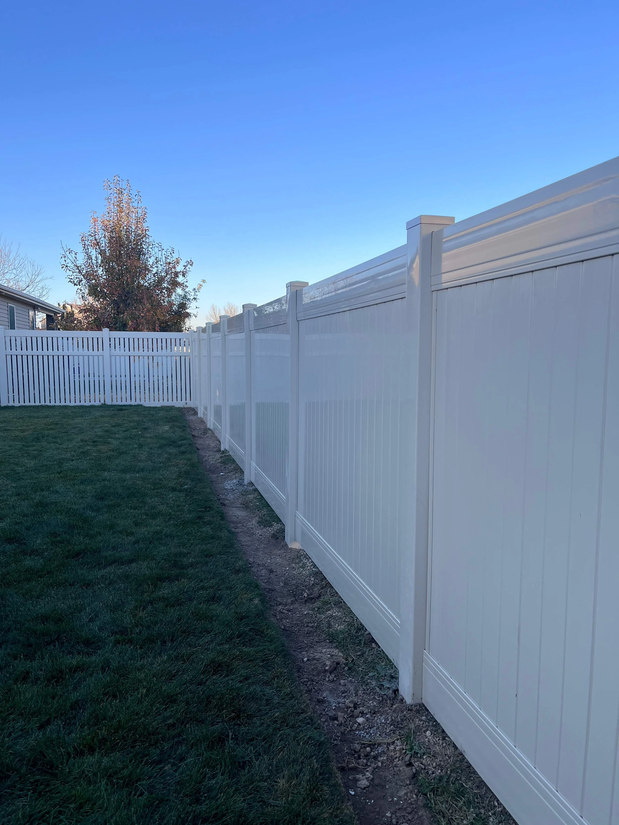 White vinyl privacy fence installed at a residential property in Salt Lake City