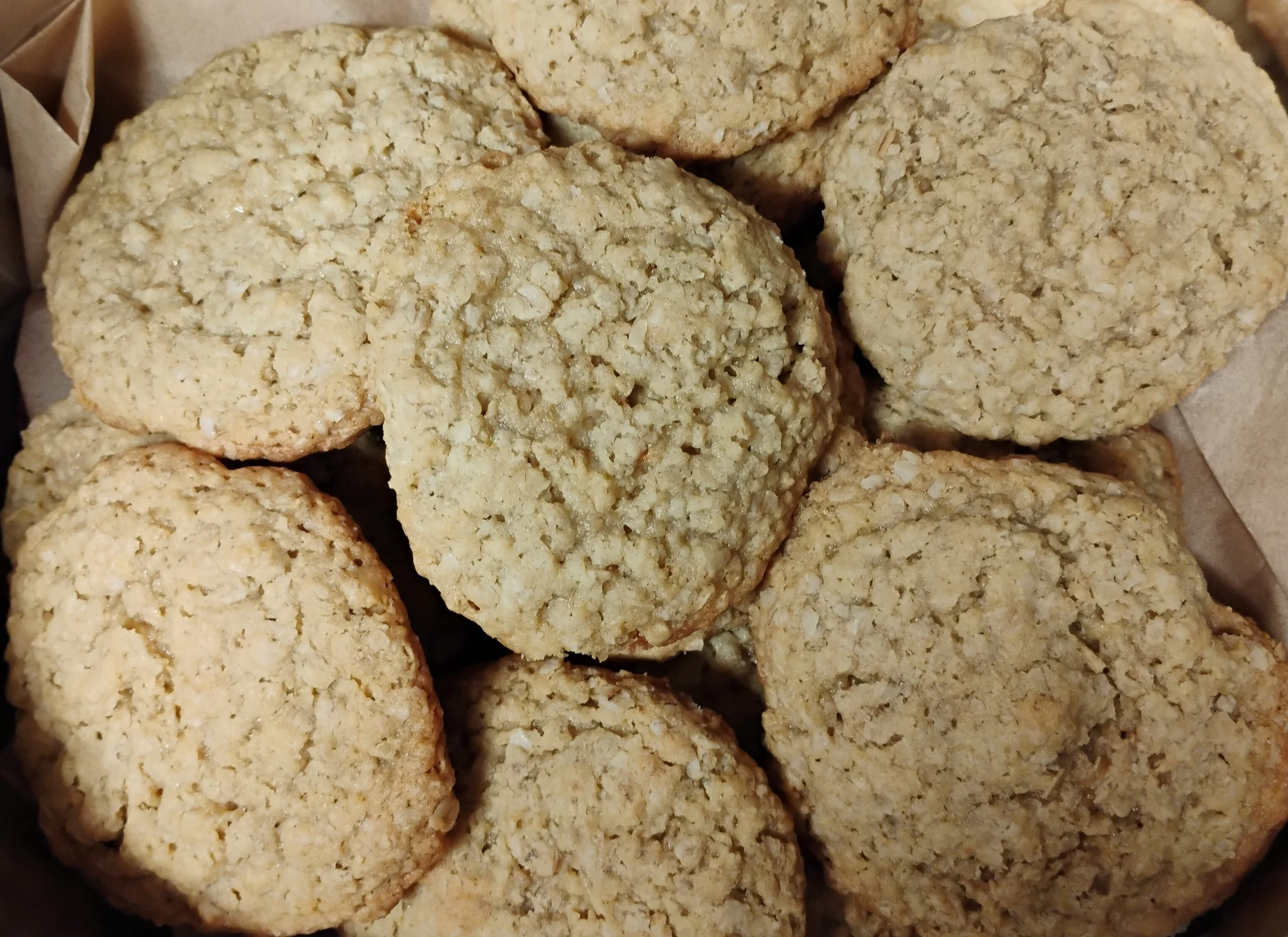 Close-up of several oatmeal cookies stacked together in a basket.