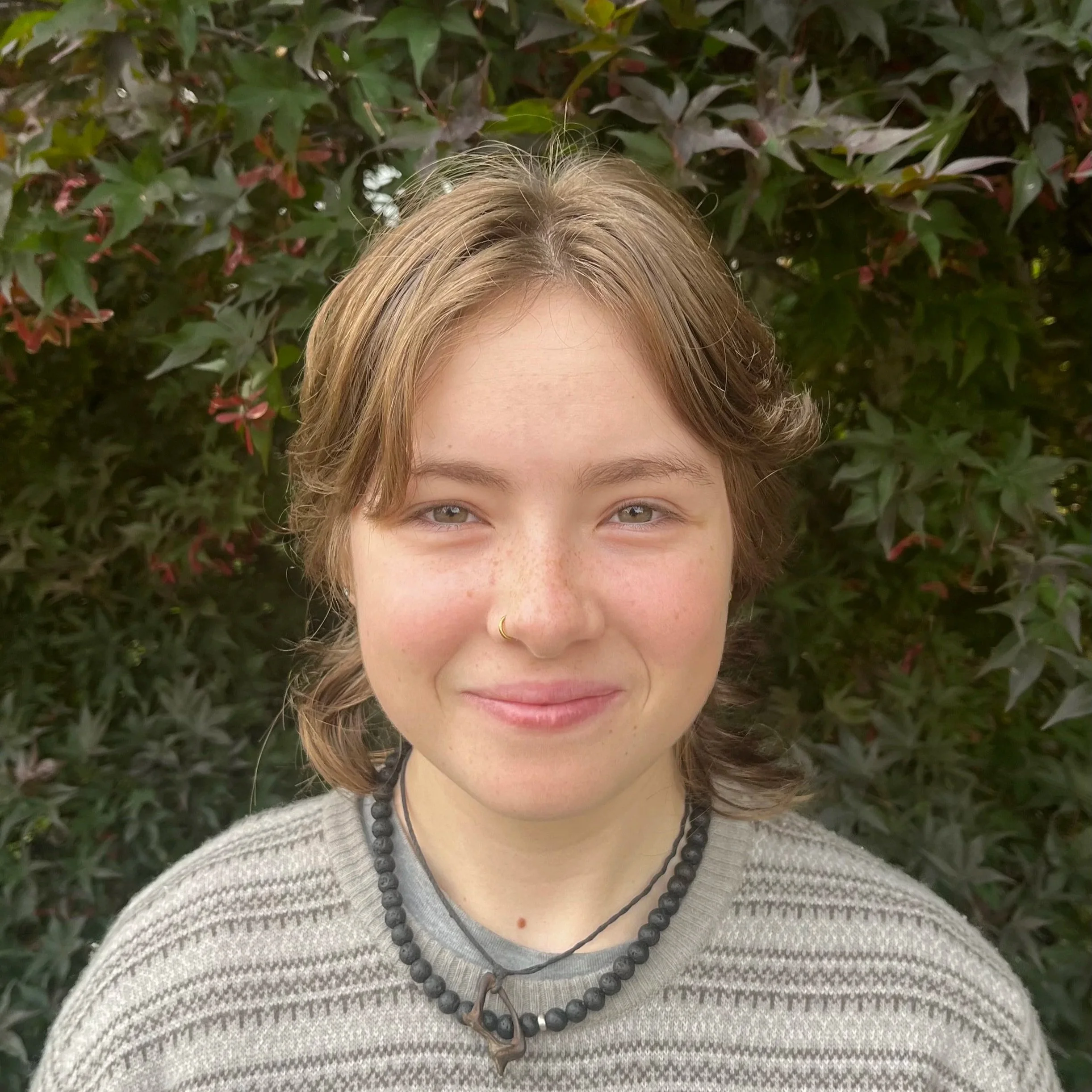 Baya, a queer and non-binary neurodivergence-affirming therapist offering online counselling in BC.