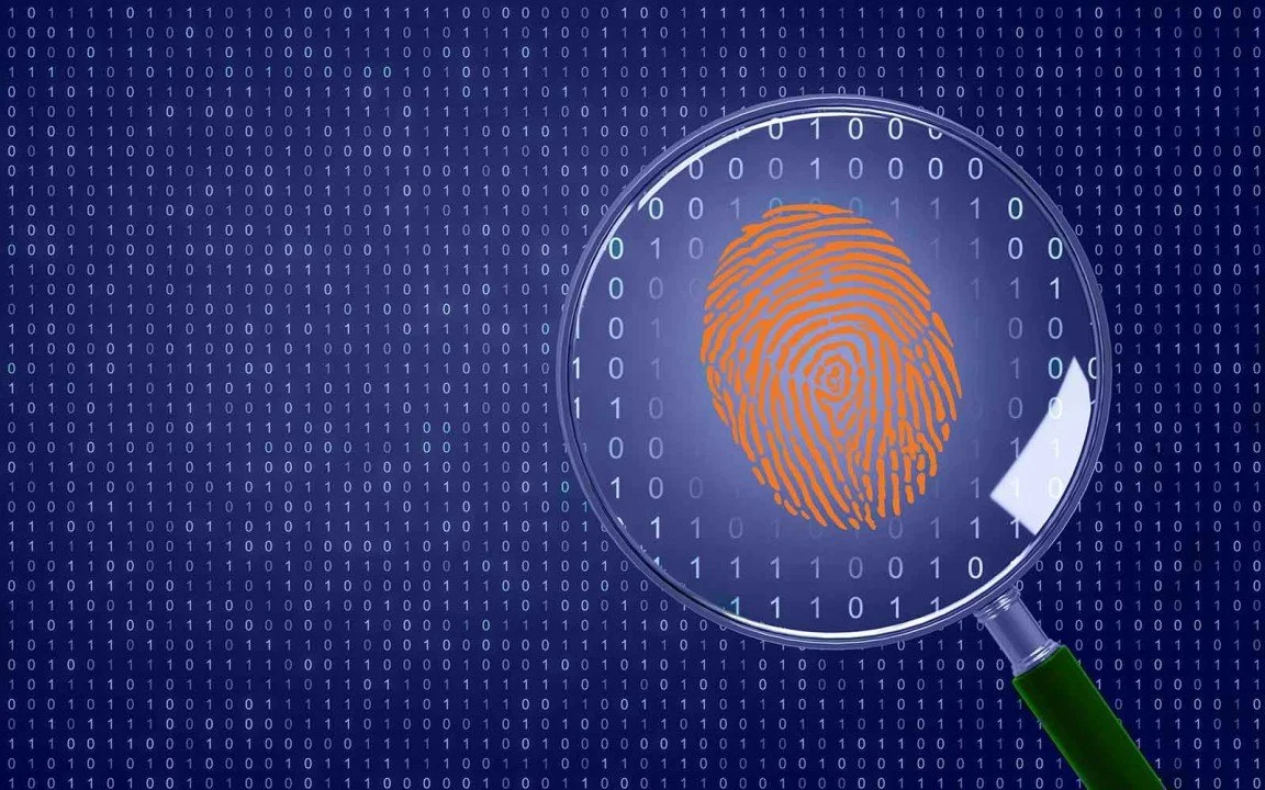 Magnifying glass revealing a digital footprint over binary code, symbolizing OSINT and digital investigations