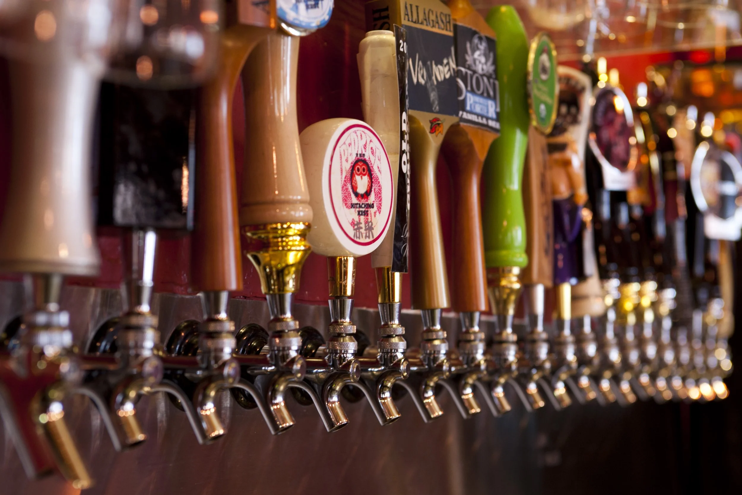 A row of beer taps in a craft brewpub.