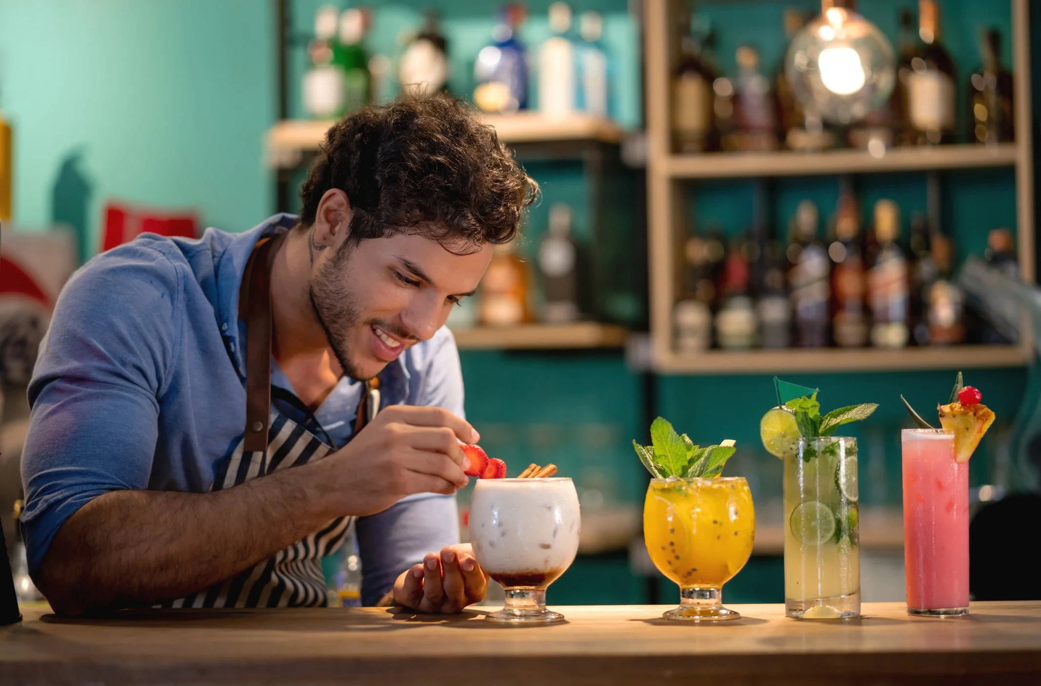A bartender practicing mixology skills.