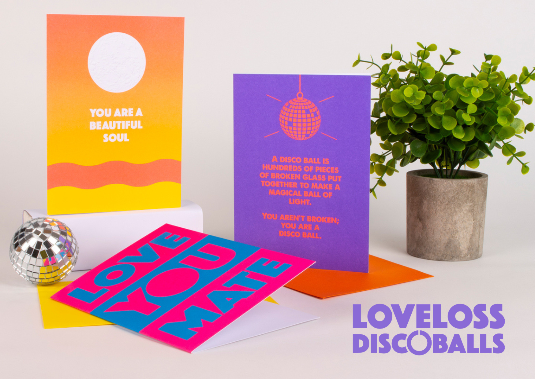 Text in purple letters reads "LOVELOSS DISC OBALLS" with a disc-shaped O in the word "DISC". The background is white.