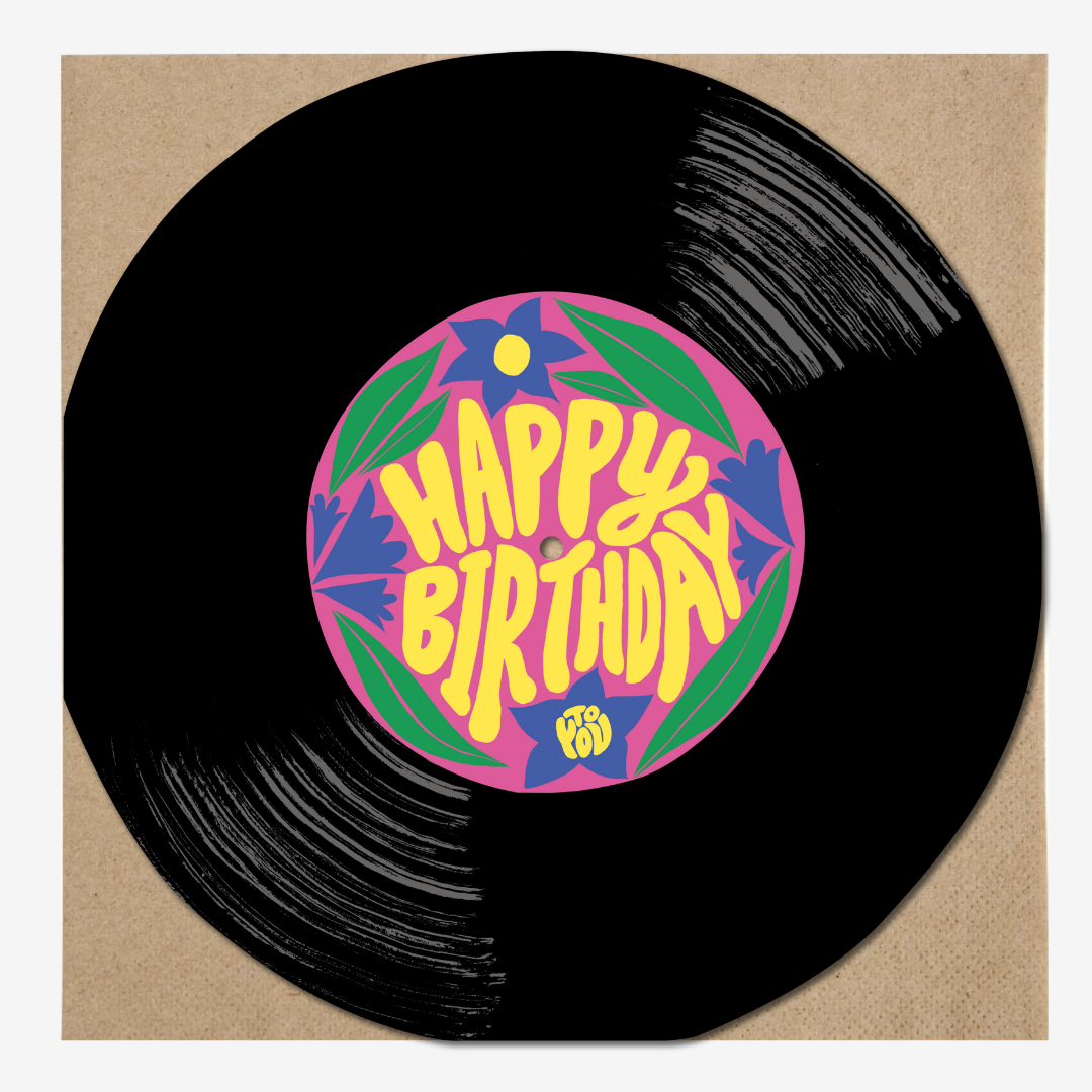 A black vinyl record with a colorful label in the center that reads "Happy Birthday" with decorative floral patterns and the word "To" at the bottom.