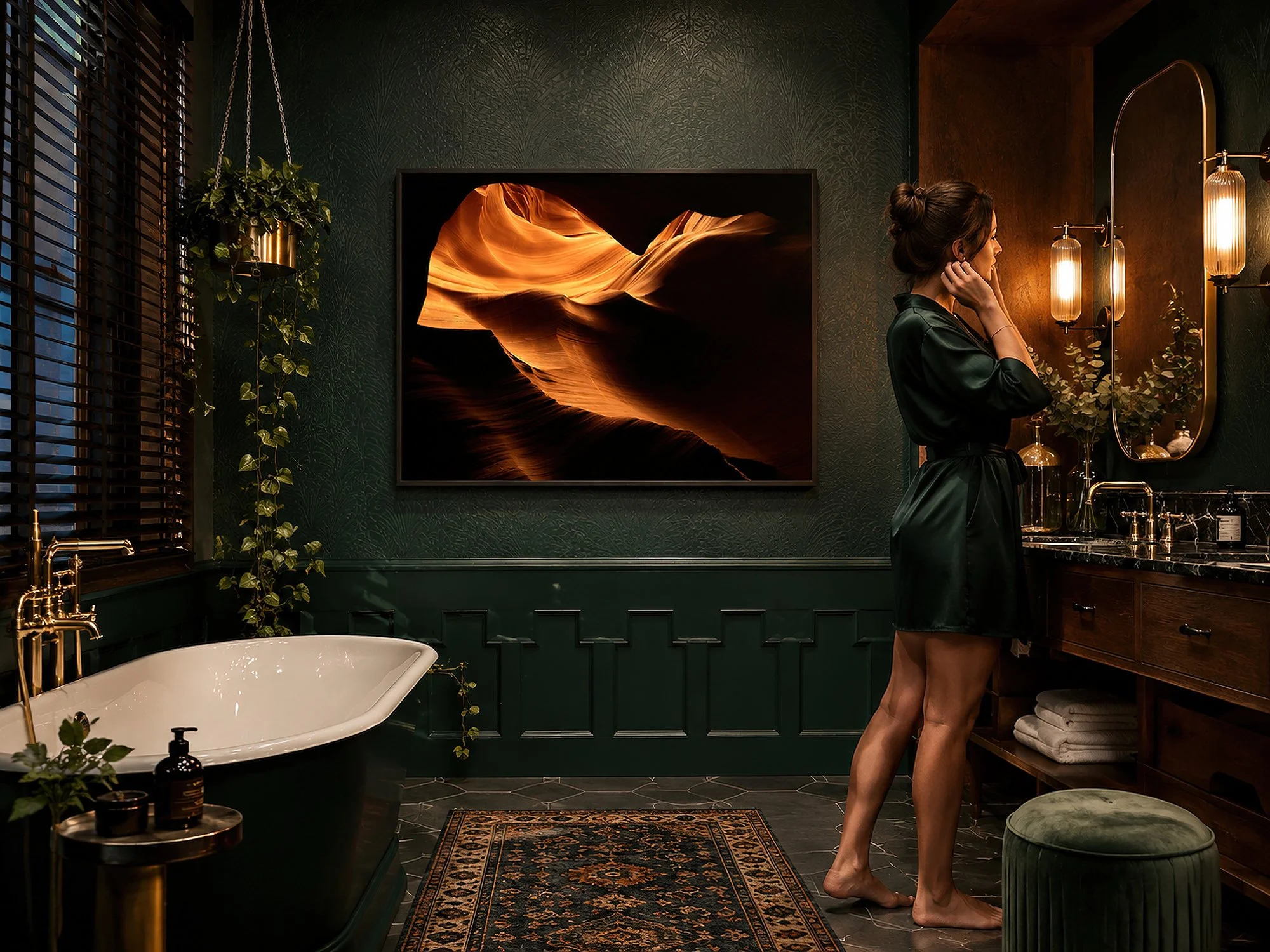 Framed Antelope Canyon photograph displayed in a dark green luxury bathroom with a woman standing at the vanity.