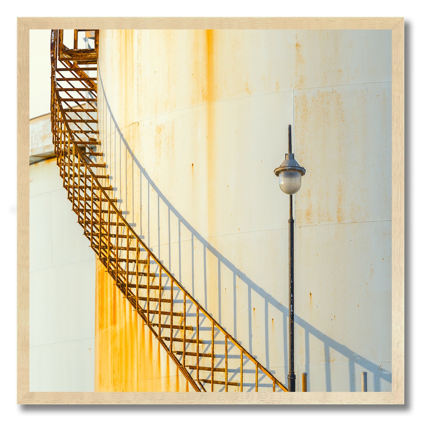 industrial staircase and lamp against rusted wall photograph