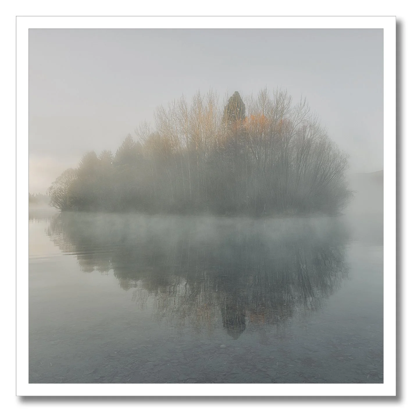 photograph of misty island reflection on lake in twizel new zealand