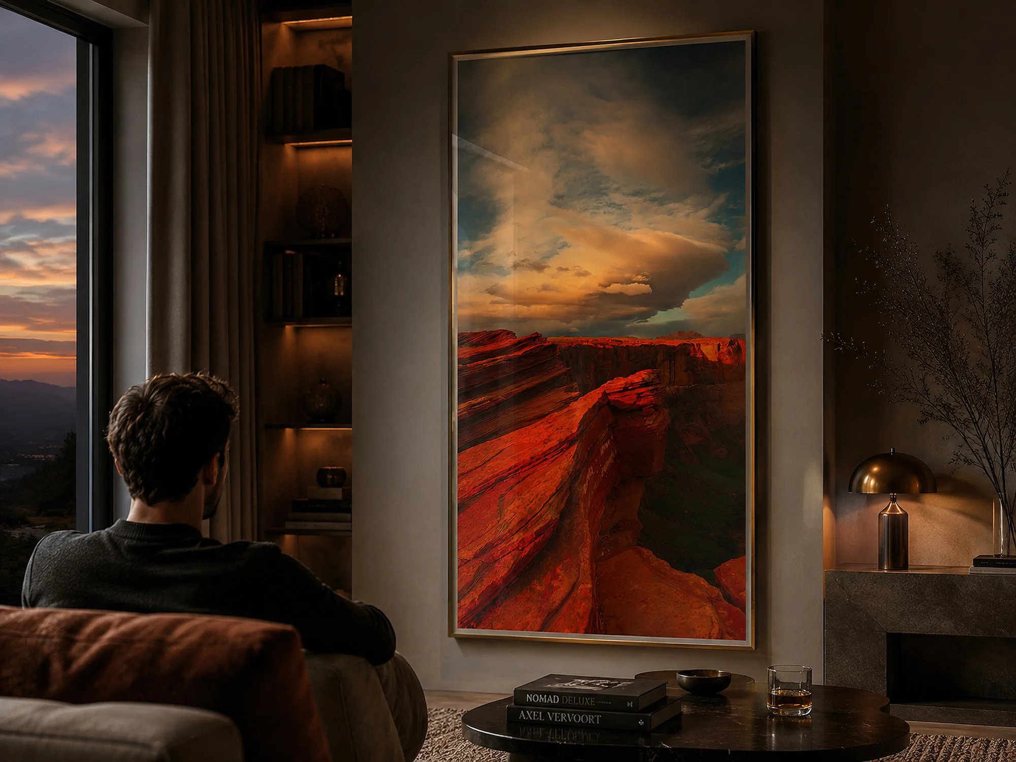 Framed Arizona canyon photograph displayed behind reflective glass in a warmly lit contemporary lounge with a seated man.