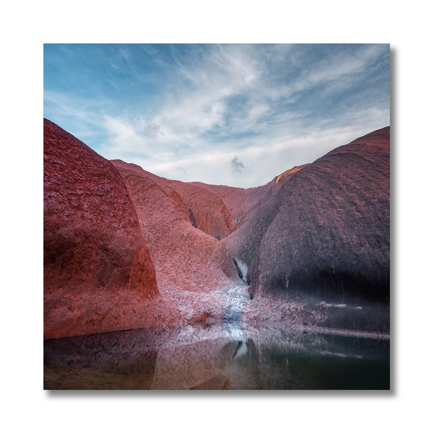 photograph of mutitjulu waterhole at uluru with reflections on still water