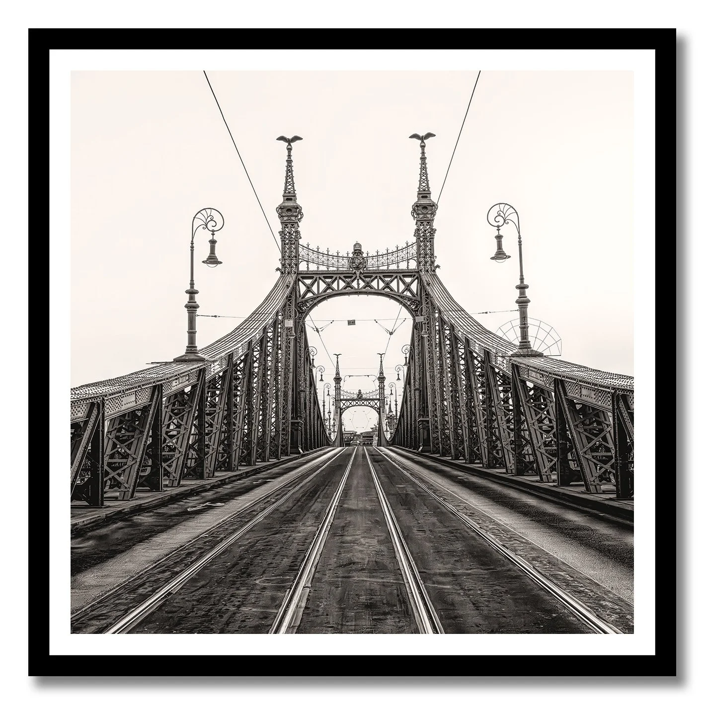 Black and white photograph of Liberty Bridge in Budapest with tramlines