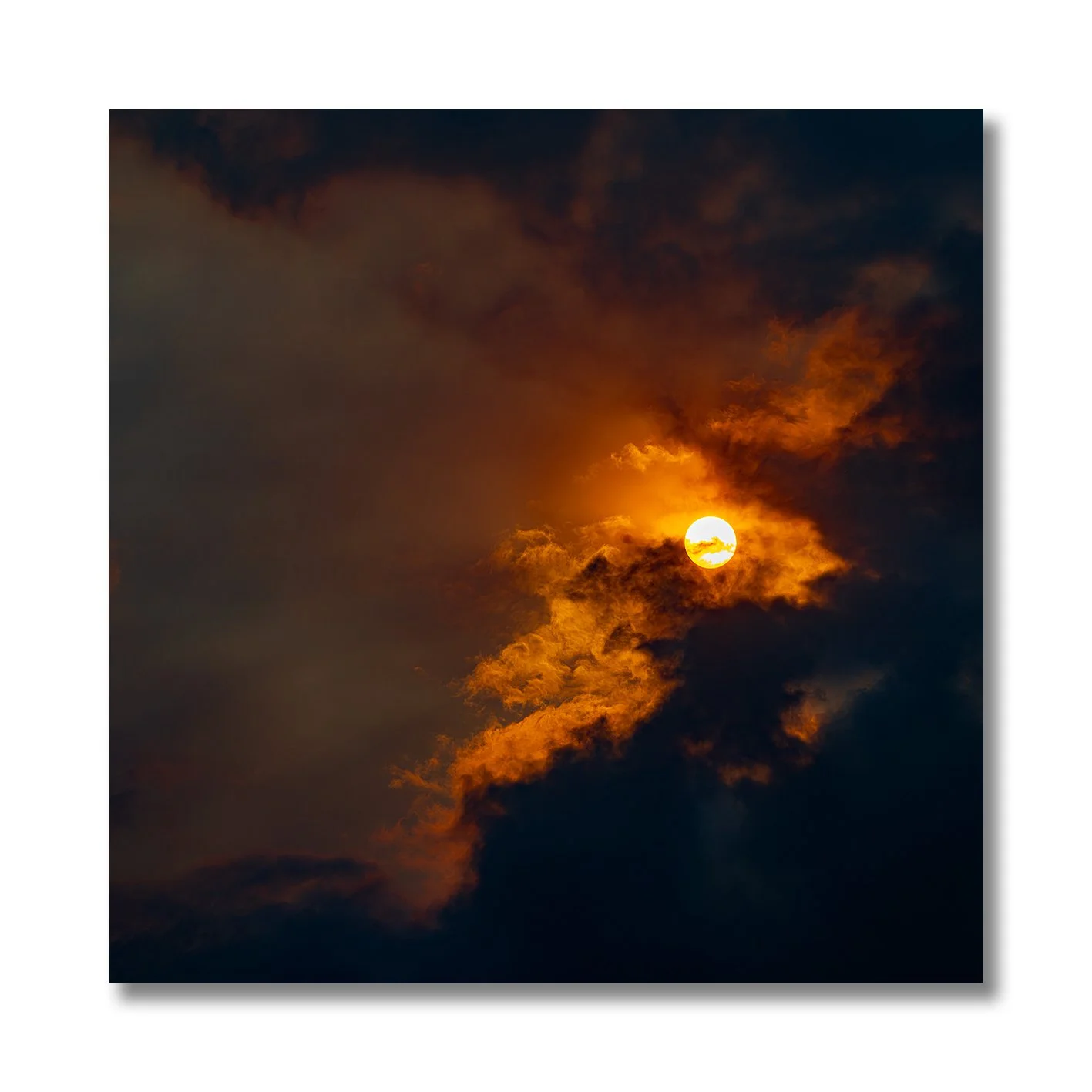 Sun breaking through golden clouds in a dramatic fine art photograph