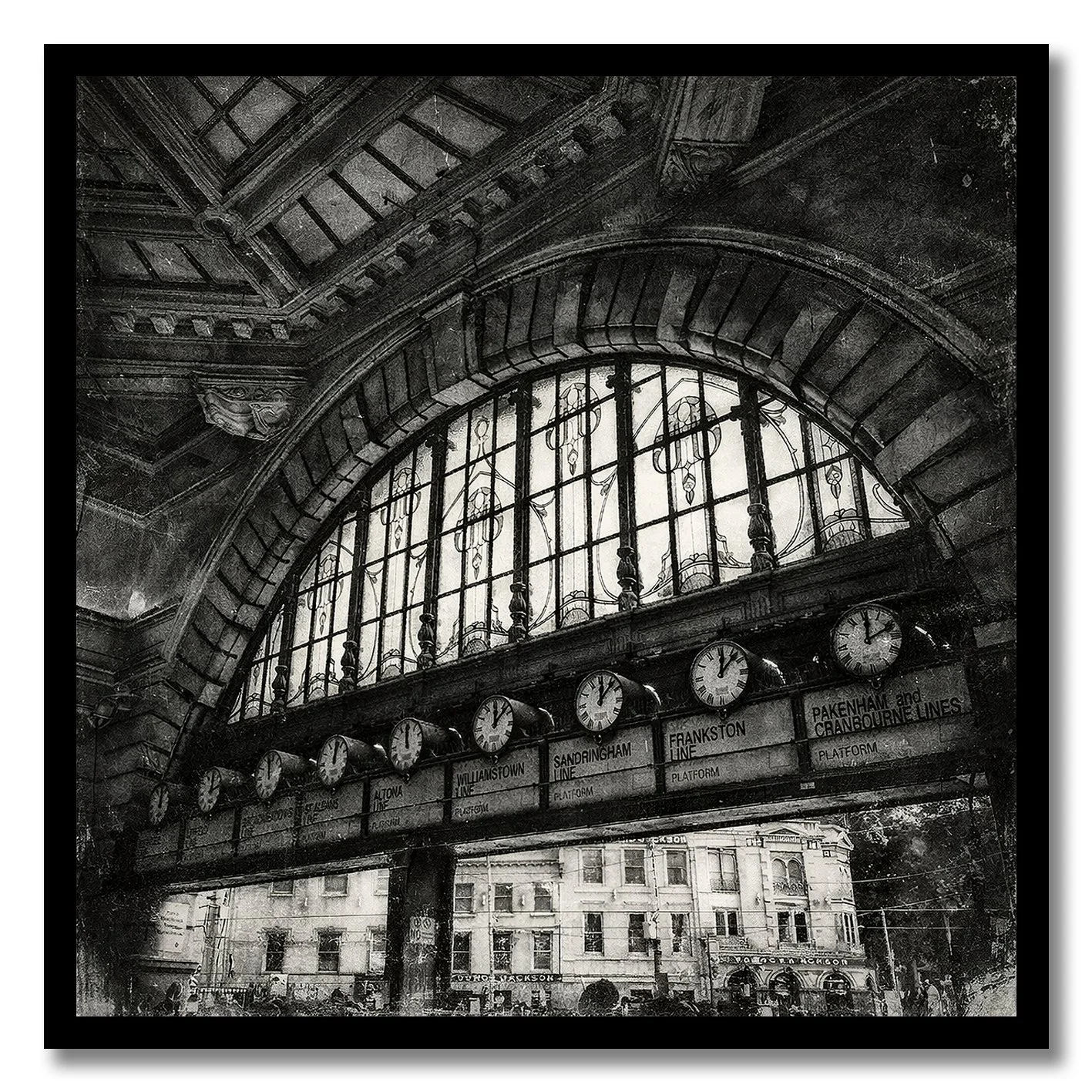 Black and white photograph of Flinders Street Station clocks under arched window