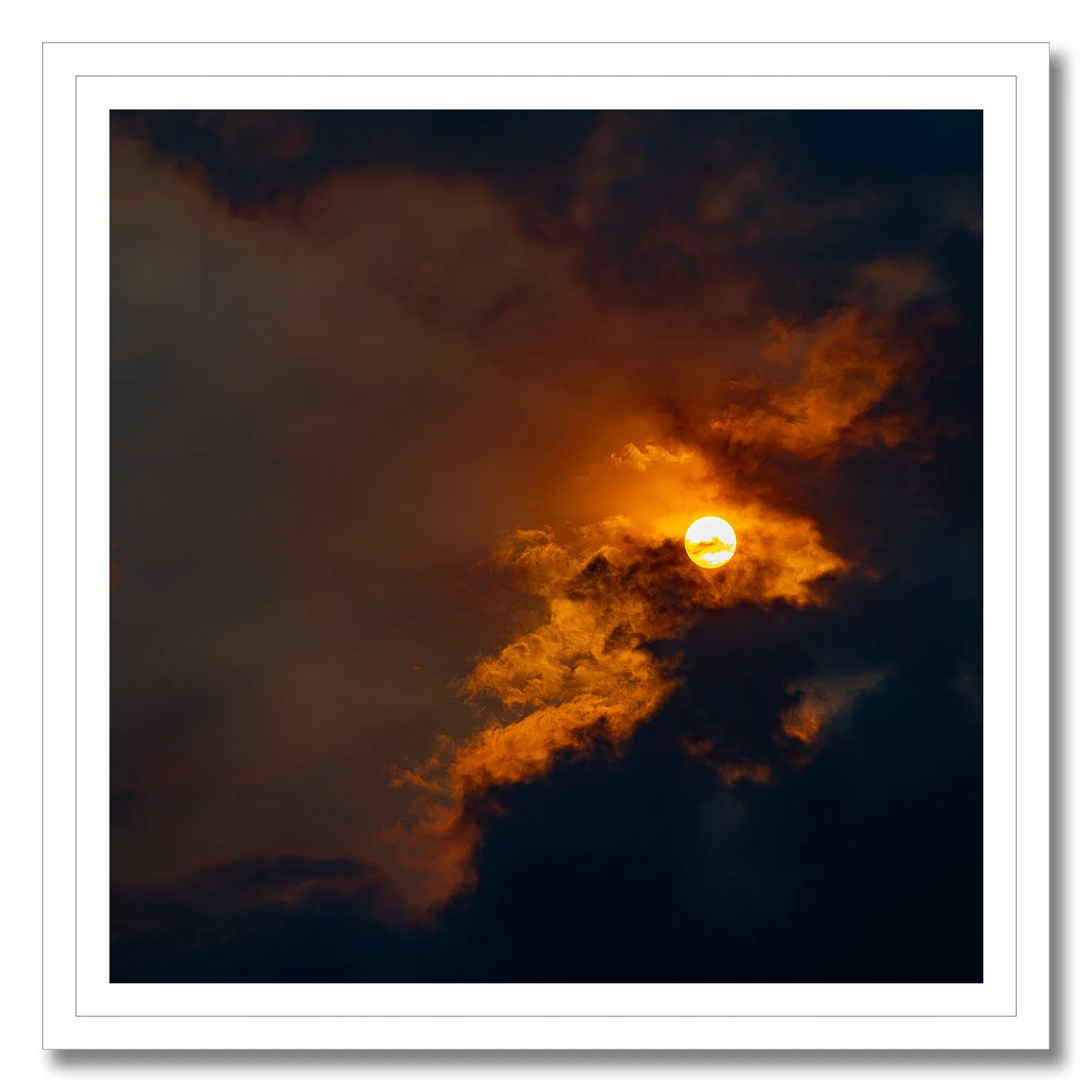 Sun breaking through golden clouds in a dramatic fine art photograph