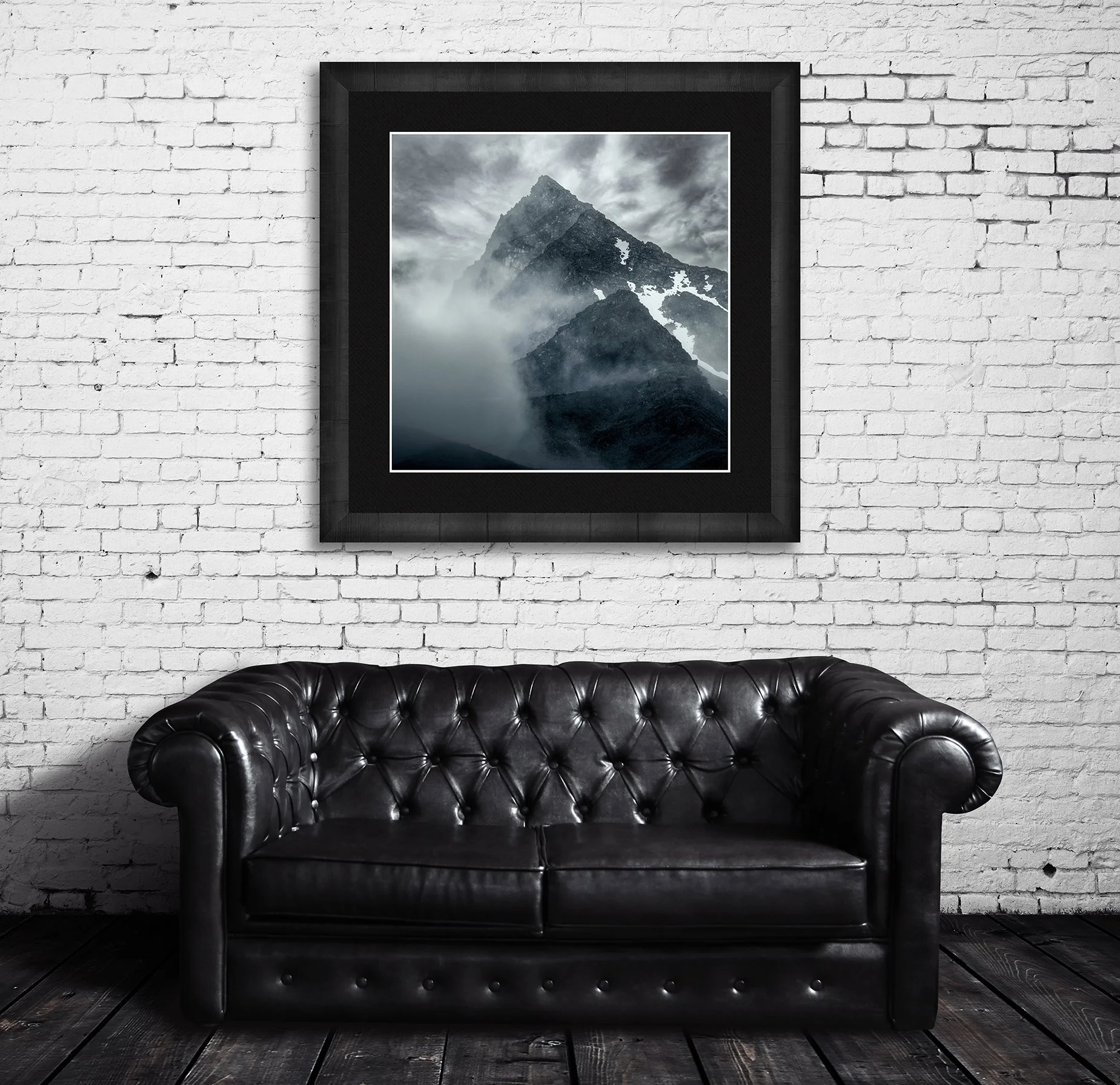 Mountain photograph emerging through mist and cloud with rugged alpine peak