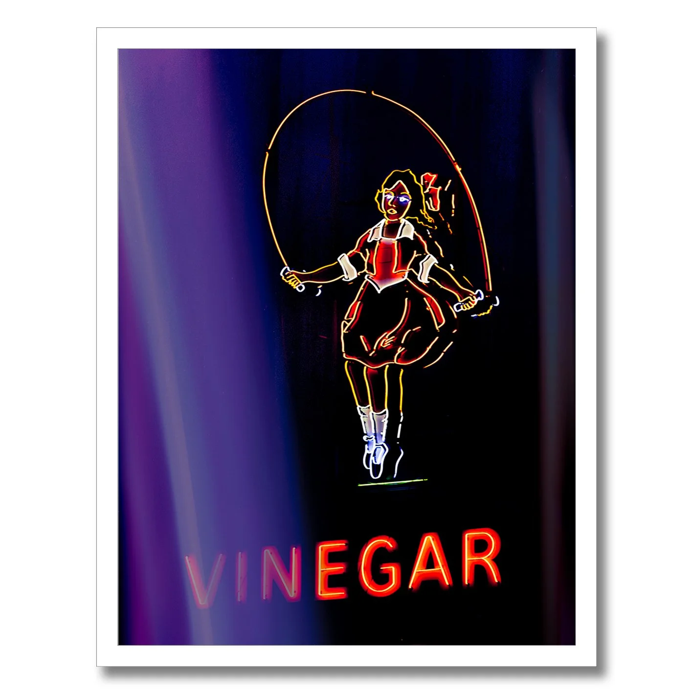 Neon photograph of Skipping Girl sign behind purple curtain light