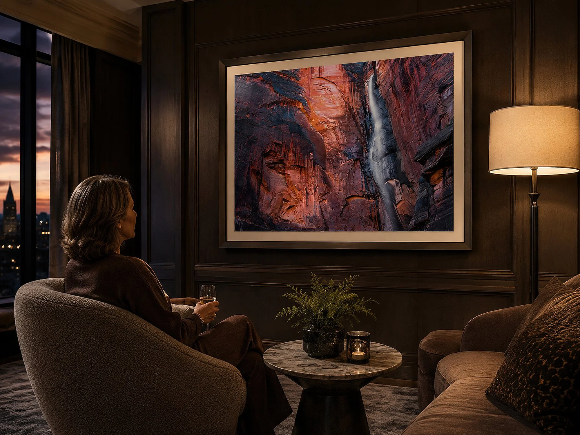Framed Zion National Park waterfall photograph displayed in an elegant evening lounge with a seated woman.