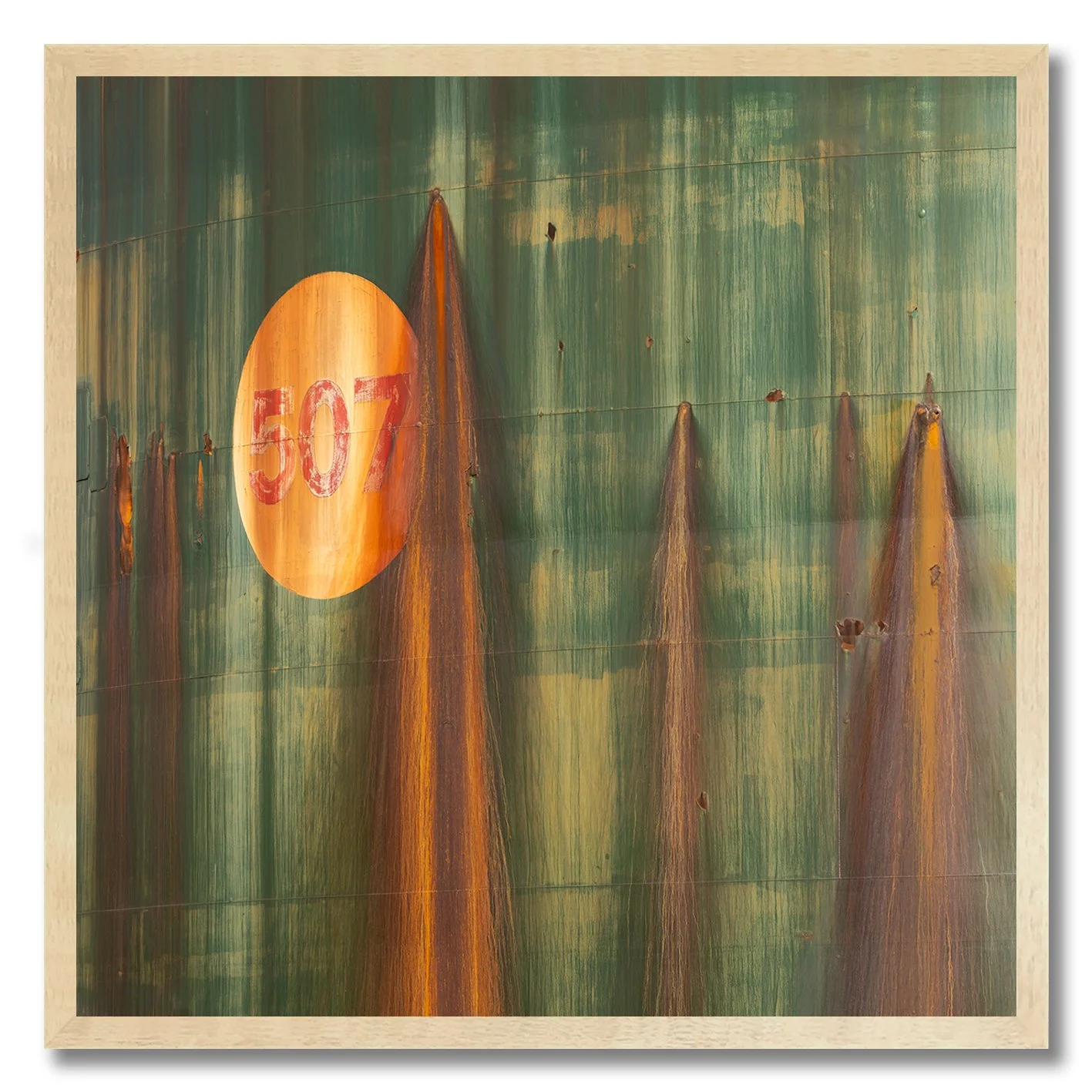 rust streaks on green industrial tank with orange circle photograph