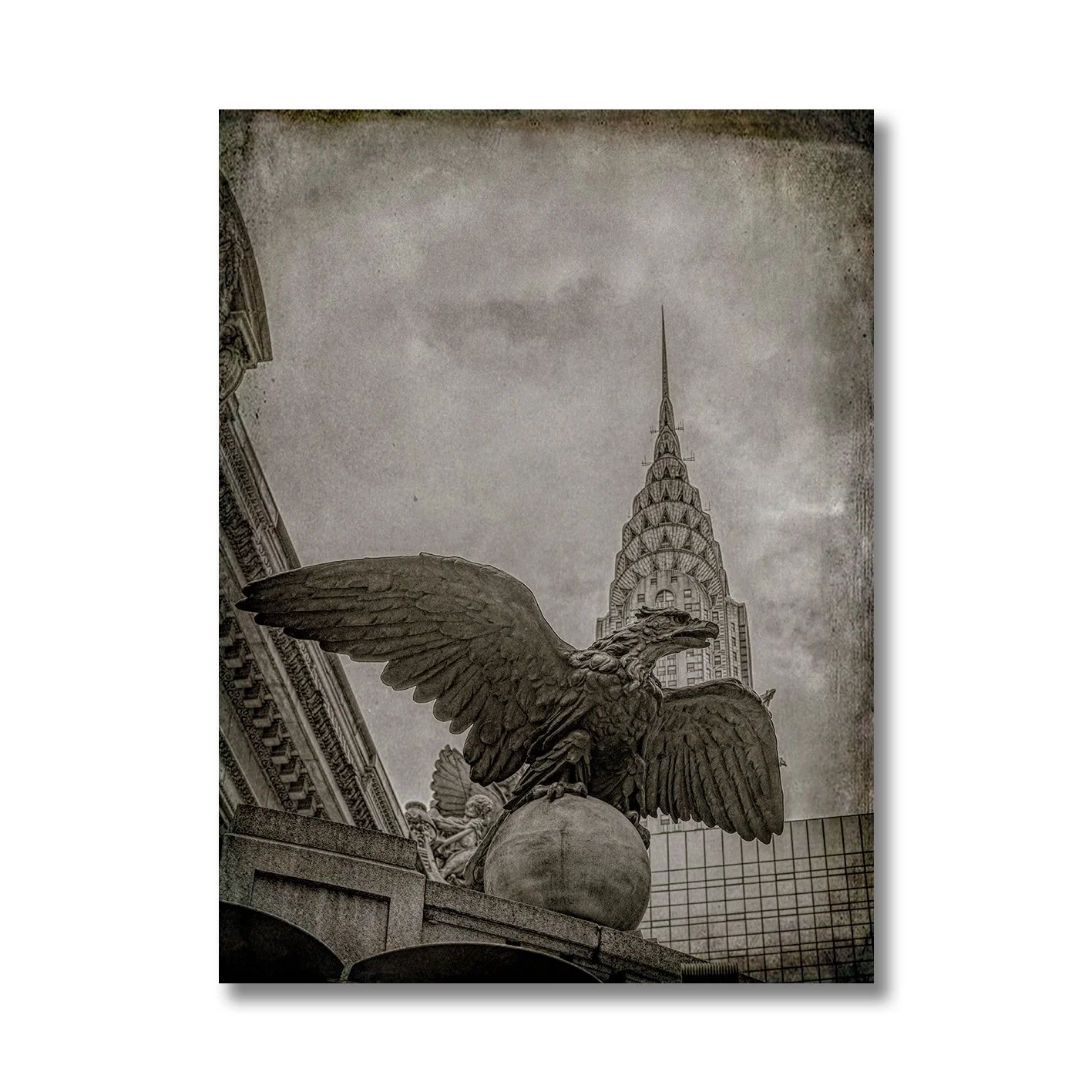 black and white photograph of grand central eagle with chrysler building behind