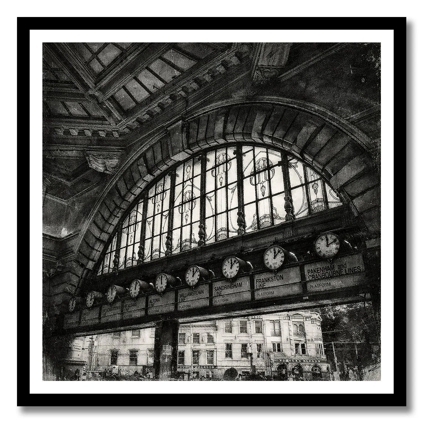 Black and white photograph of Flinders Street Station clocks under arched window
