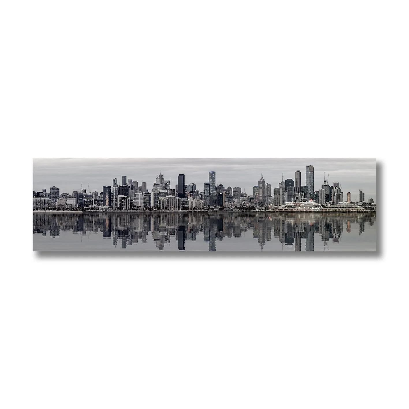 black and white photograph of melbourne skyline reflected on calm water