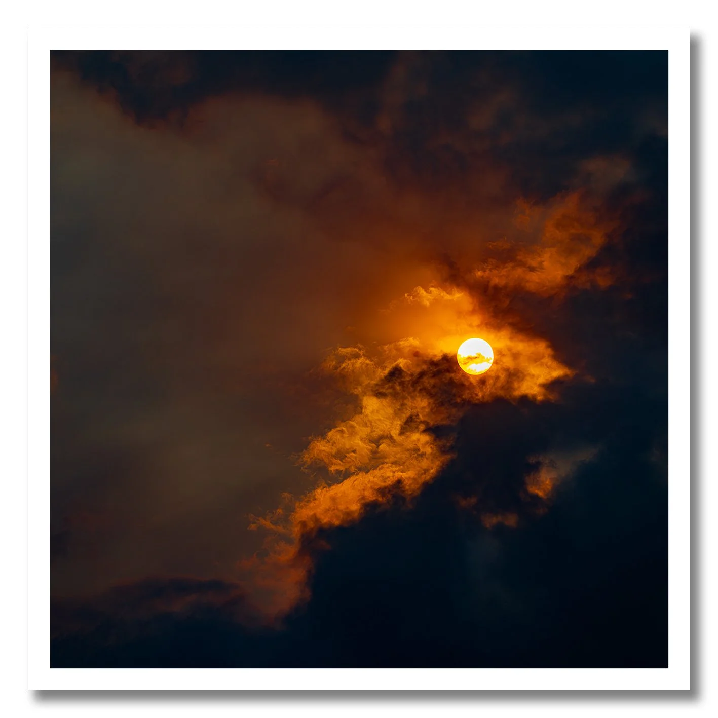 Sun breaking through golden clouds in a dramatic fine art photograph