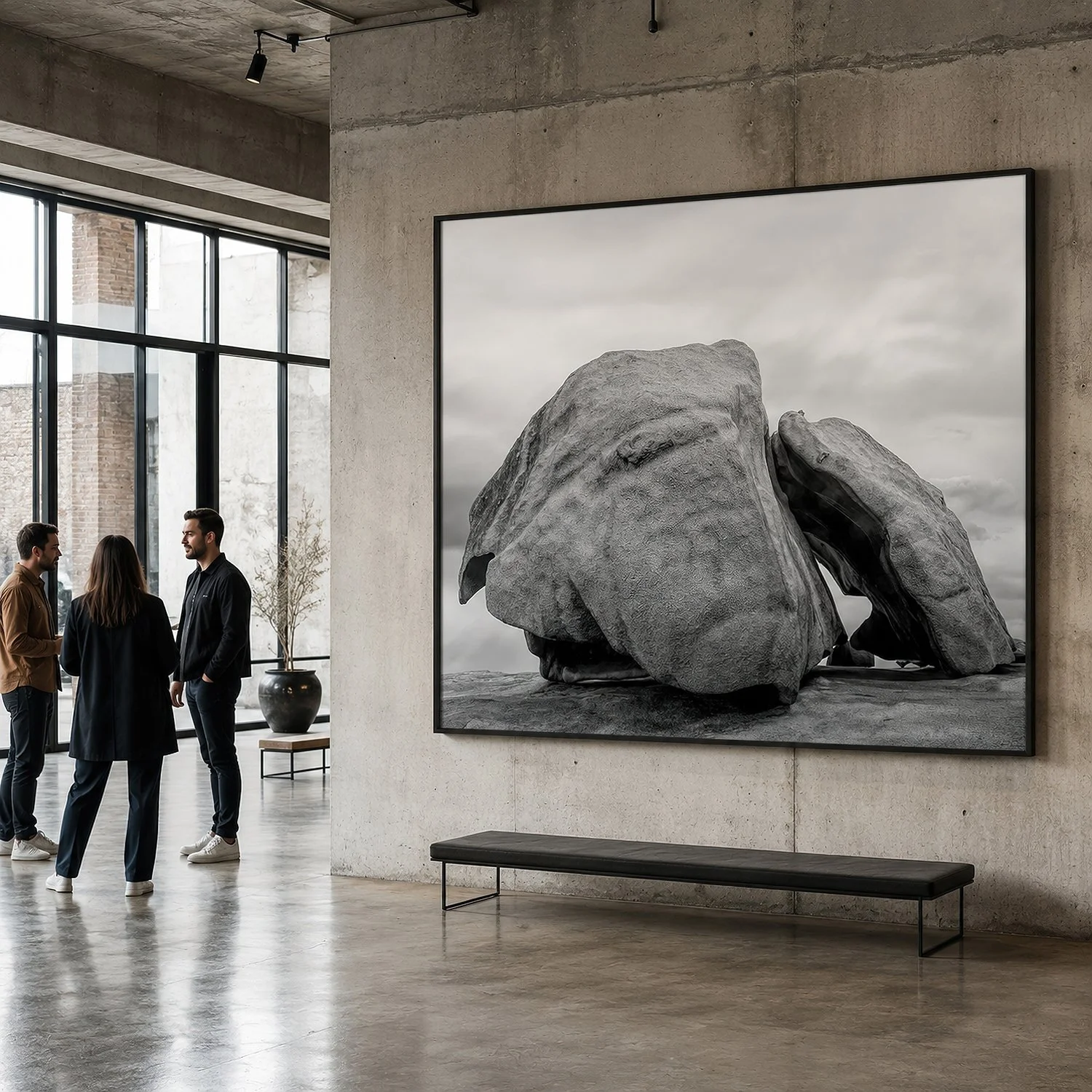 Large framed black-and-white rock photograph in a minimalist concrete warehouse gallery with visitors by Nick Psomiadis at NIKART Studio and Gallery