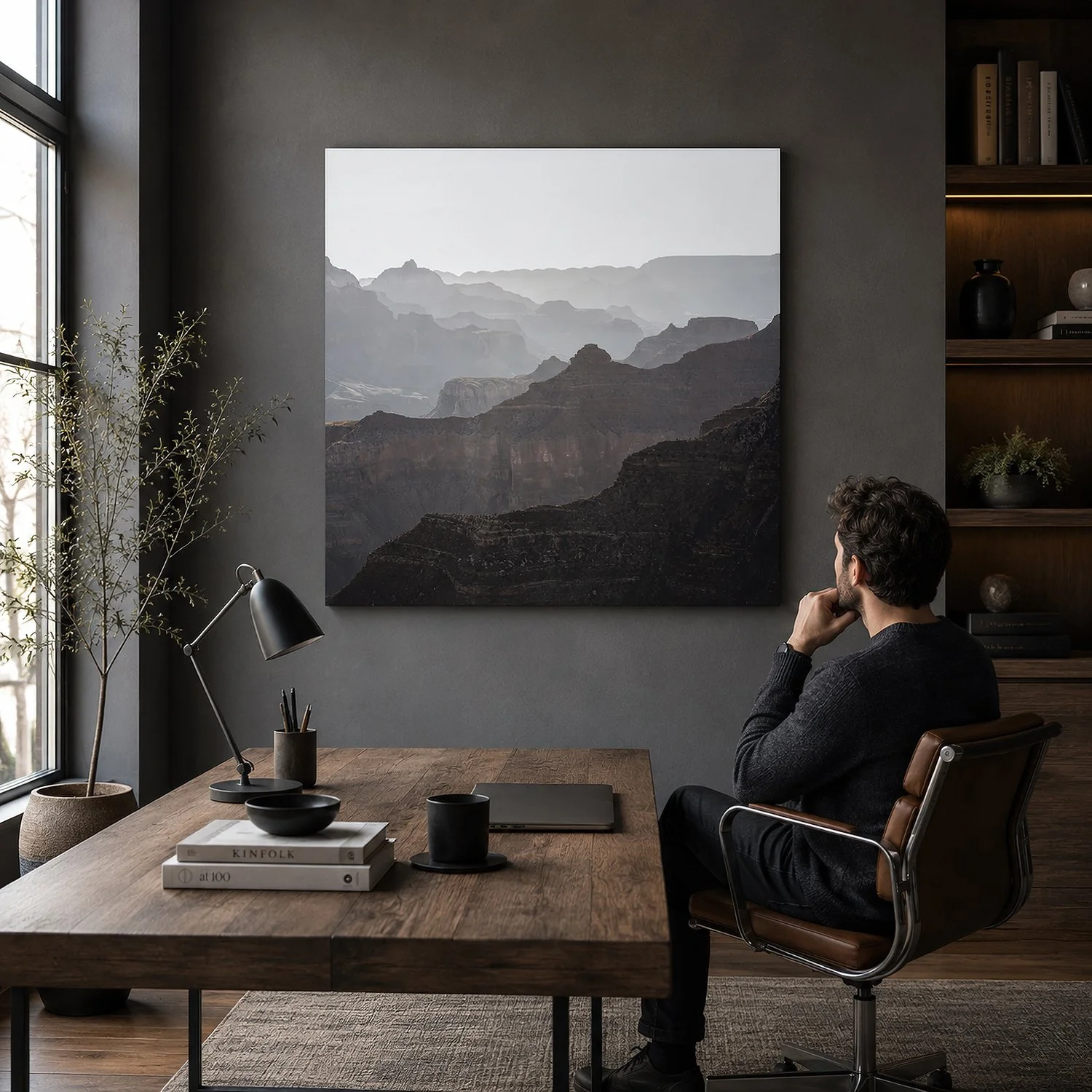 Square Grand Canyon photograph displayed in a modern home office with a seated man.