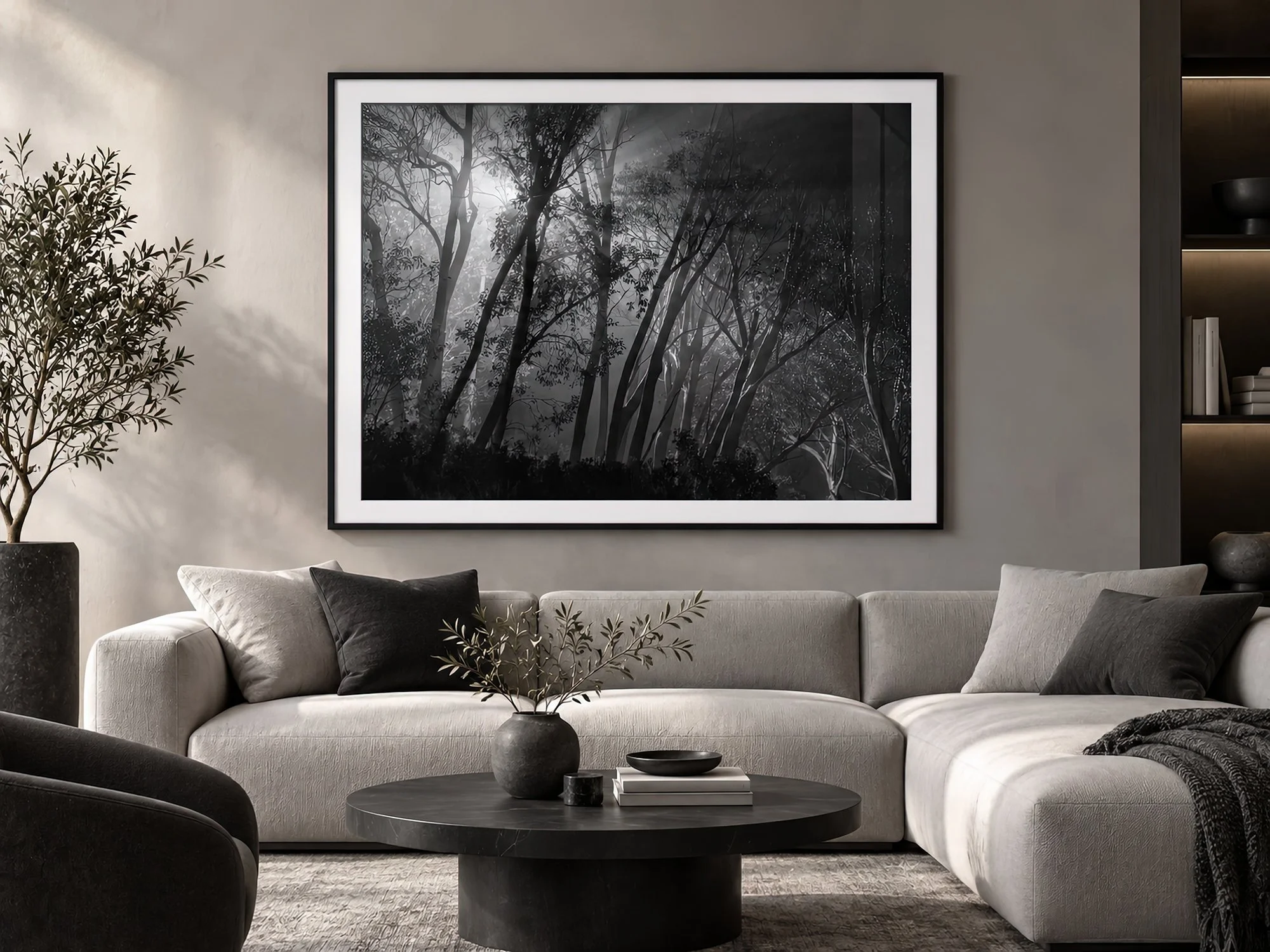 Framed black and white forest photography with dramatic light through trees in a sophisticated monochrome lounge by Nick Psomiadis at NIKART Studio and Gallery