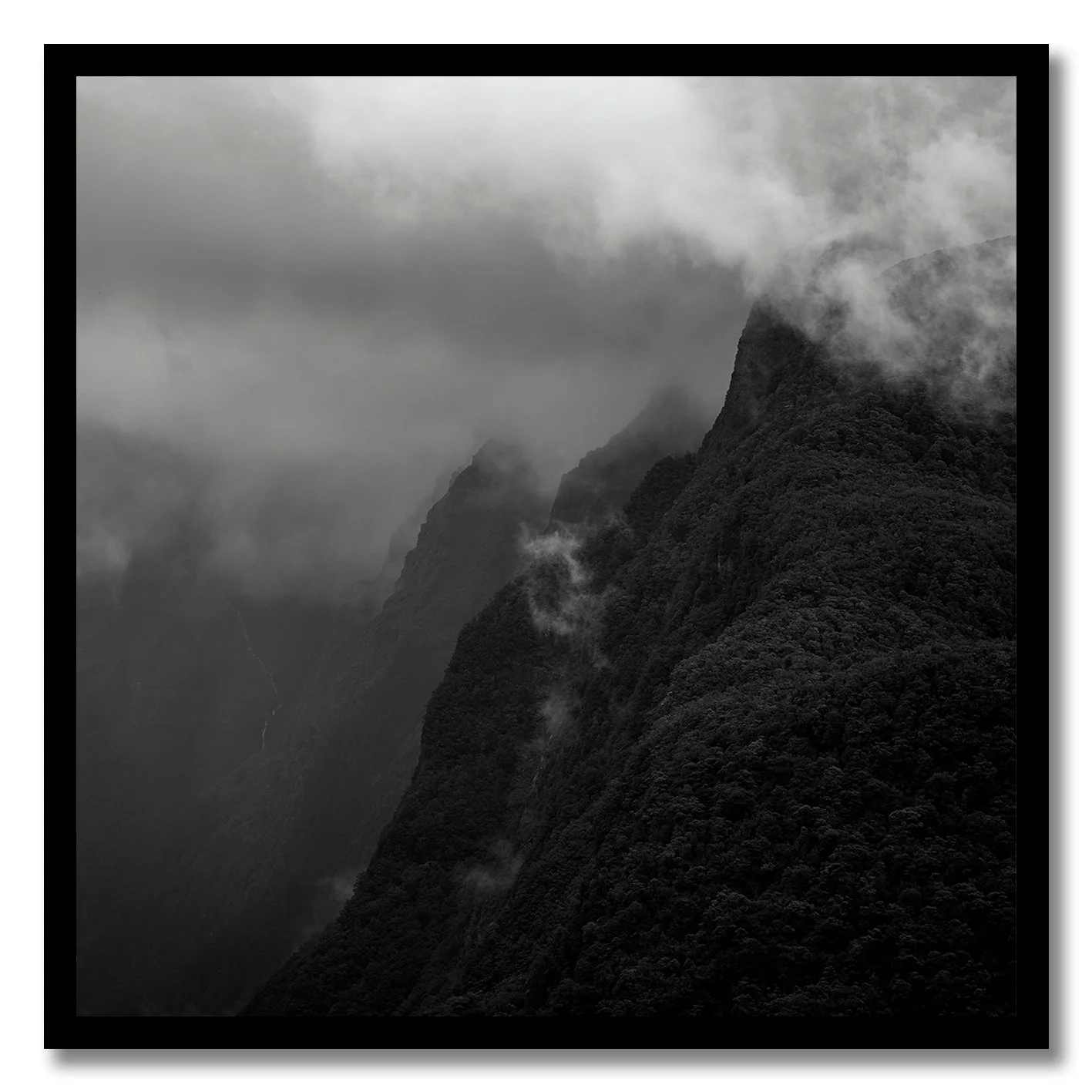 black and white photograph of misty mountain landscape