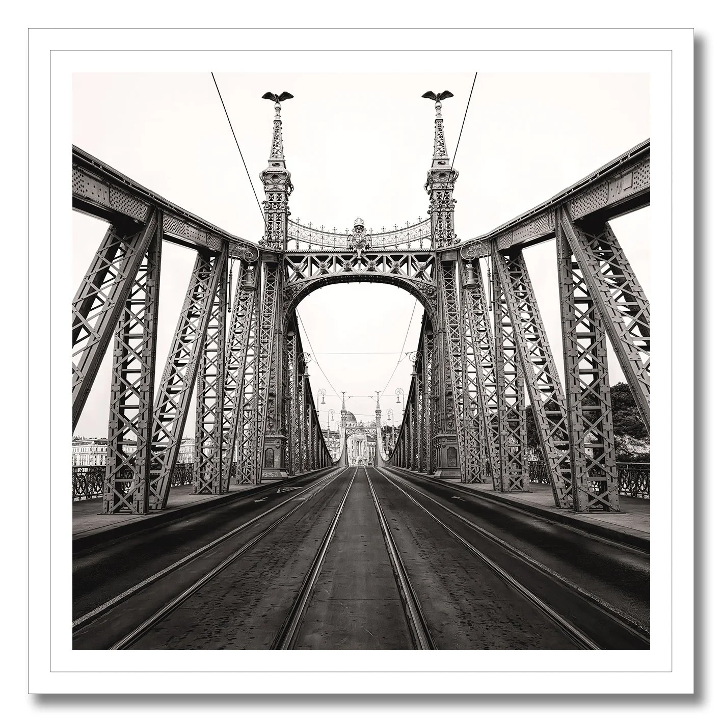 Black and white photograph of Liberty Bridge in Budapest with tramlines