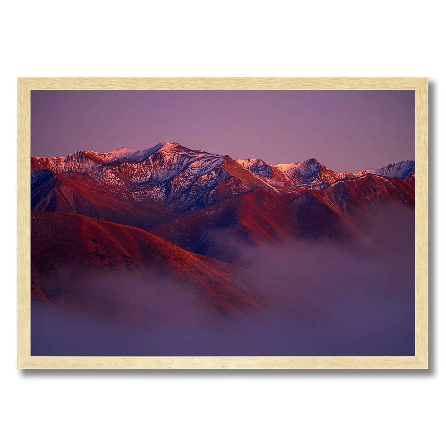Mountain landscape photograph with alpenglow light on snowy peaks and misty valleys