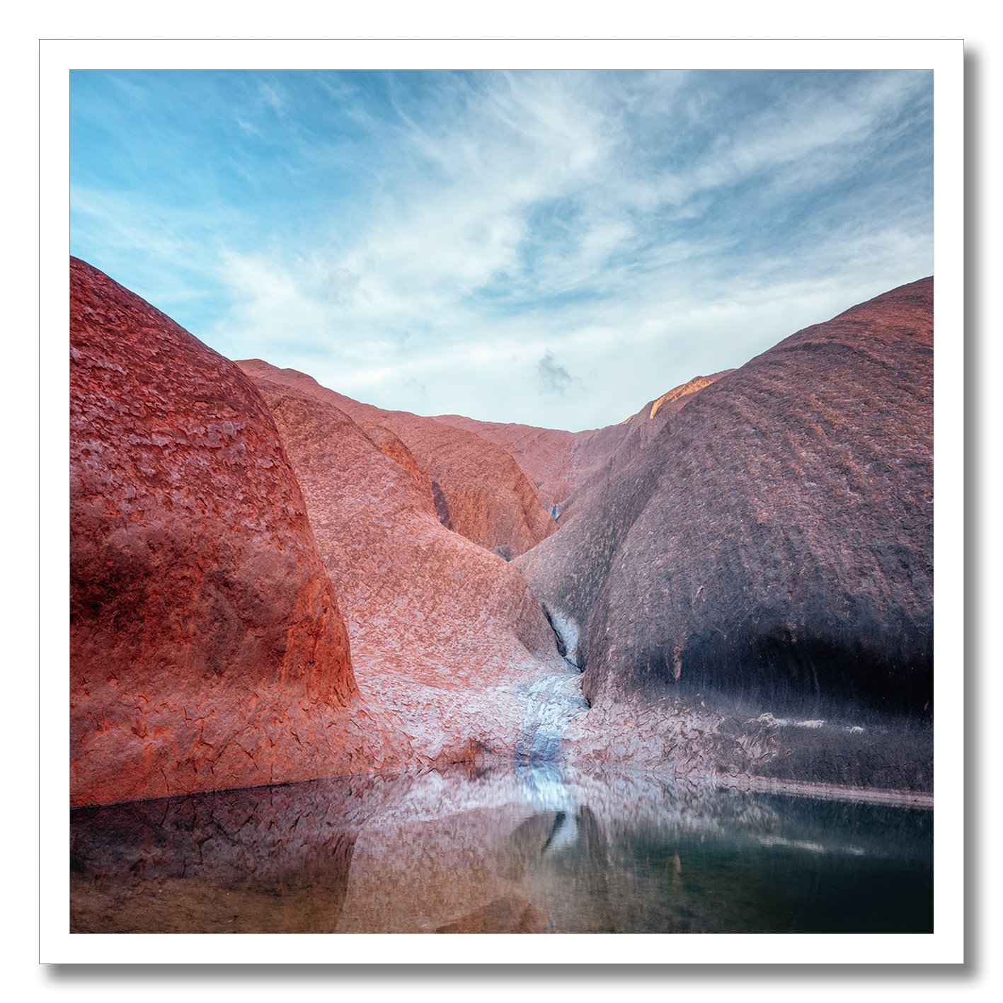photograph of mutitjulu waterhole at uluru with reflections on still water