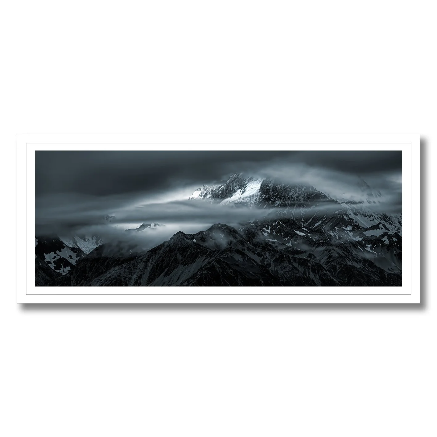 Moody photograph of snow-covered Southern Alps and drifting cloud near Glentanner