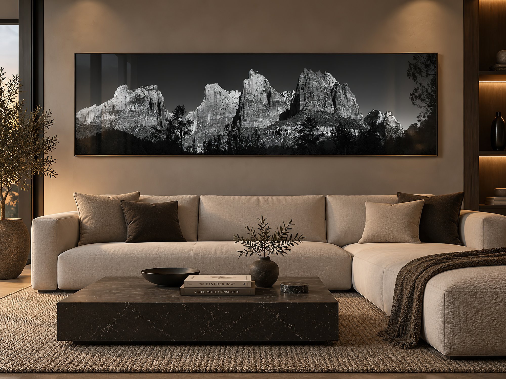 Minimalist lounge with warm ambient lighting and neutral furnishings, featuring a wide black-and-white mountain panorama in an elegant frame with subtle glass reflections by Nick Psomiadis at NIKART Studio and Gallery