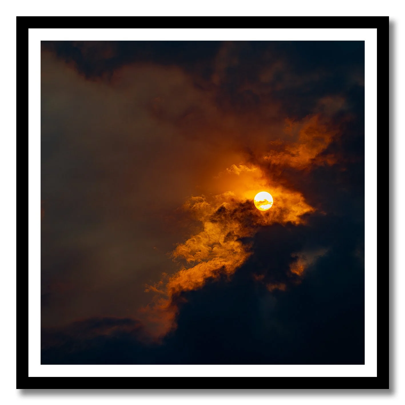 Sun breaking through golden clouds in a dramatic fine art photograph