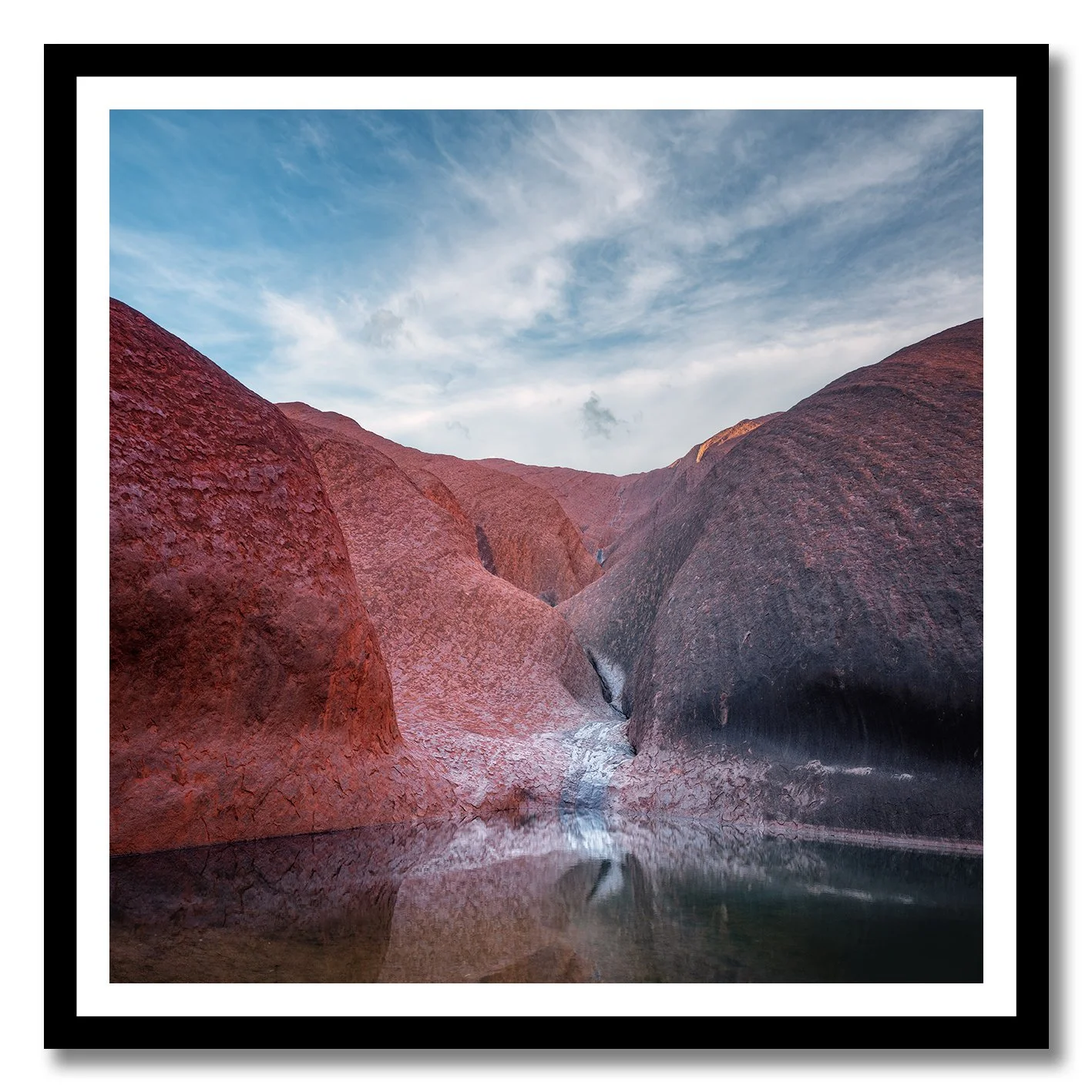 photograph of mutitjulu waterhole at uluru with reflections on still water