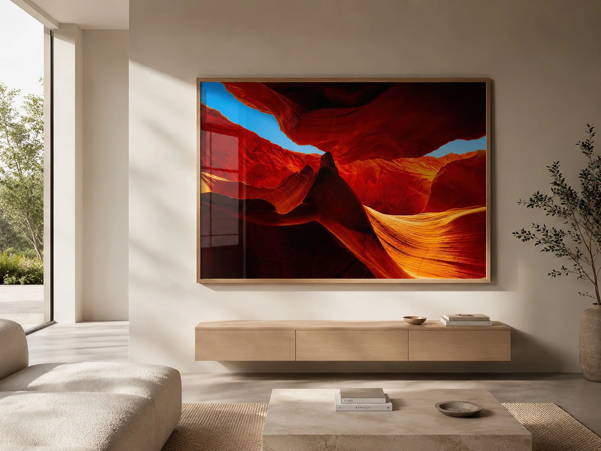 Sunlit minimalist living room with a light timber-framed Antelope Canyon photograph above a floating timber sideboard, with soft glass reflections and warm neutral décor by Nick Psomiadis at NIKART Studio and Gallery