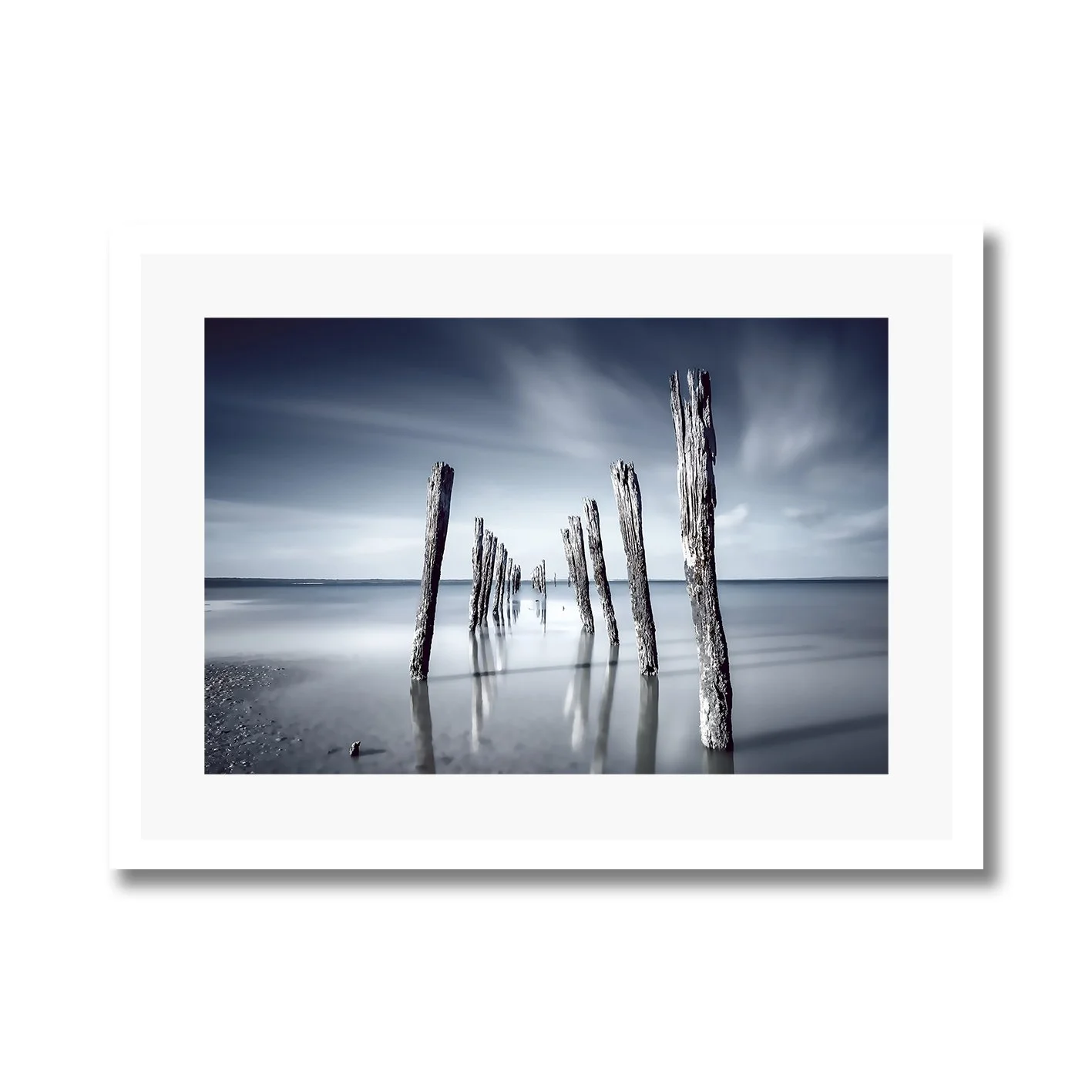 Fine art photography of weathered jetty posts at Tenby Point in calm water by Nick Psomiadis