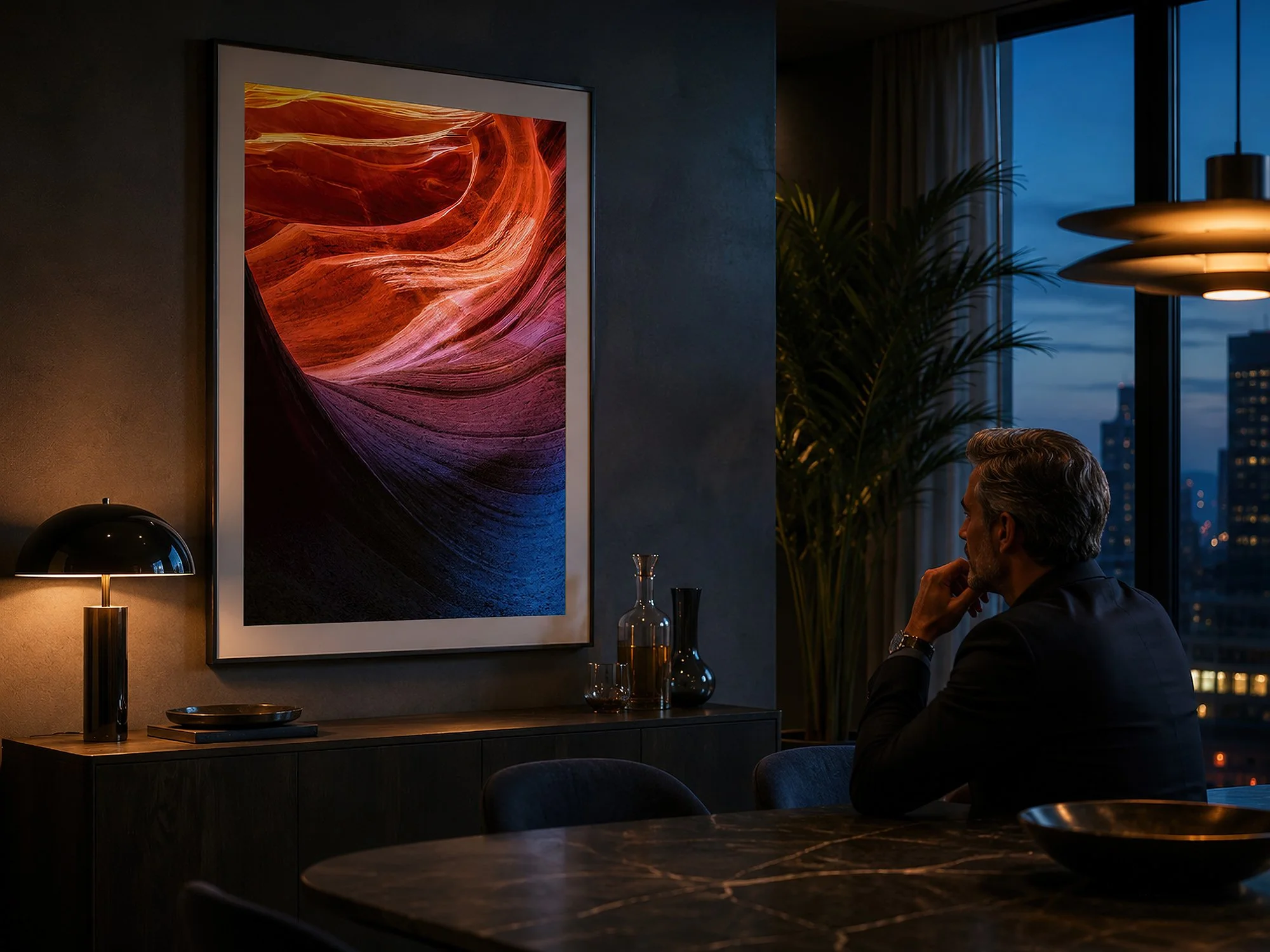 Framed Antelope Canyon photograph displayed in a moody contemporary dining room with a seated man.