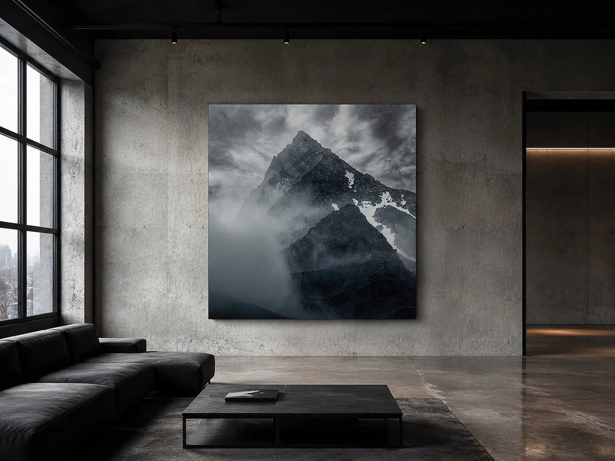 Square mountain canvas print in a minimalist industrial loft with concrete walls, polished floors, black ceiling, sparse black furniture and moody track lighting by Nick Psomiadis at NIKART Studio and Gallery