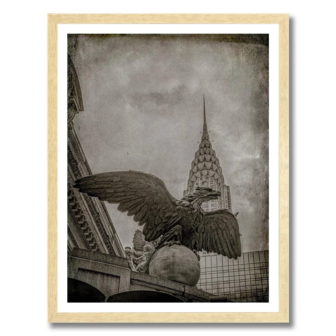 black and white photograph of grand central eagle with chrysler building behind